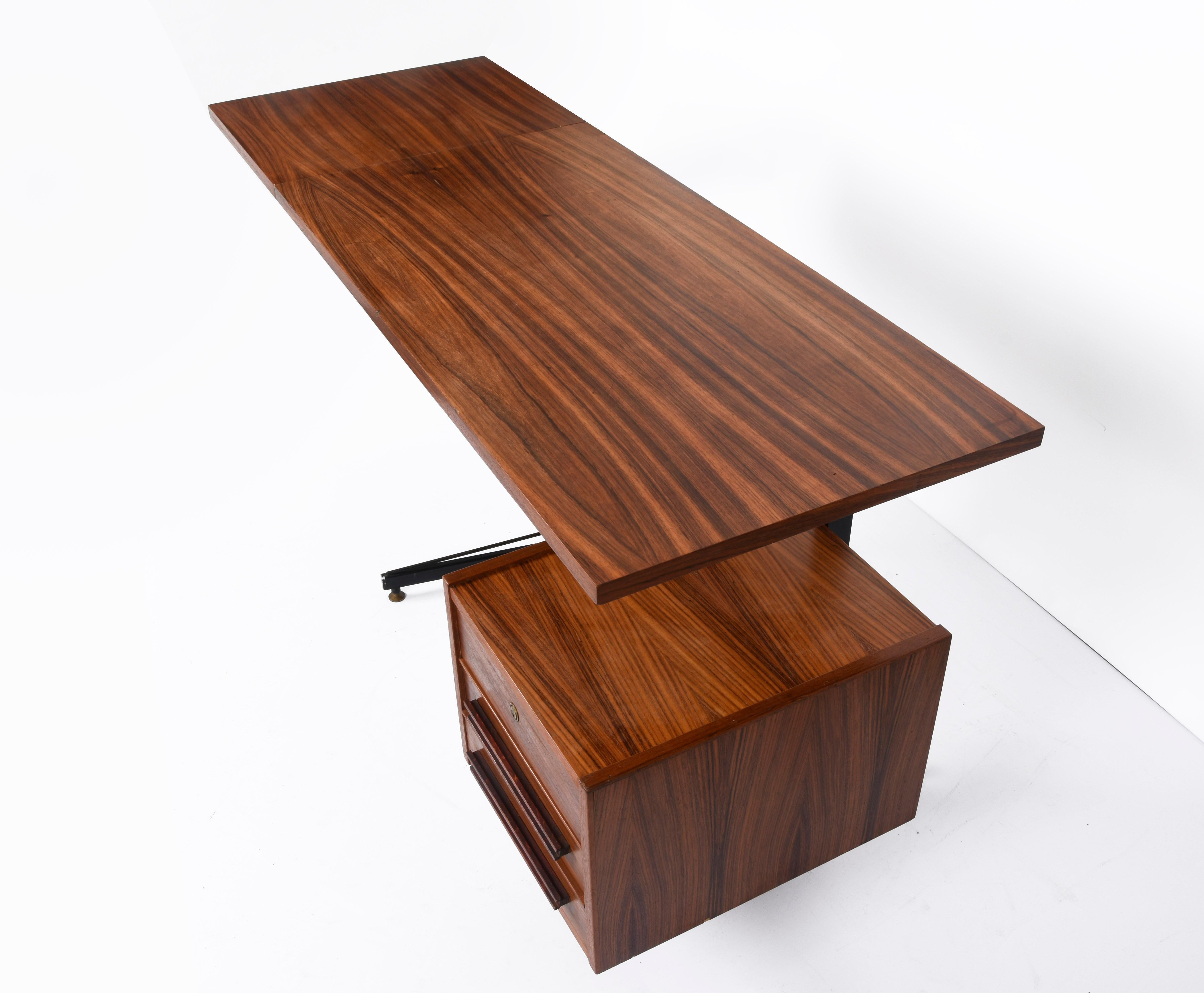 Wonderful Italian folding desk with drawers, the foldable top is made by a single piece of wood with marvellous wood grain that continues all over the top. This incredible piece was designed in Italy during the 1960s.

The desk has three drawers