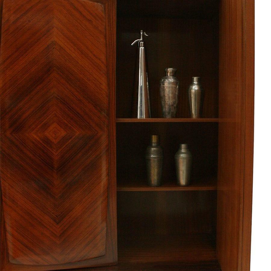 Three-door bar cabinet with interior drawers handcrafted in solid wood with feather marquetry with a high cabinetmaking. Brass finished legs. Italy 1950s.