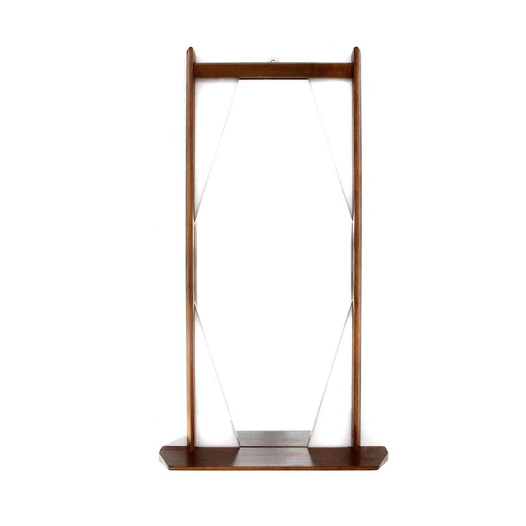 Italian manufacture mirror produced in the 1960s.
Teak frame and shelf.
Mirror with rhomboid shape.
Good general conditions, some signs due to normal use over time.

Dimensions: Length 50 cm, depth 14 cm, height 91 cm.