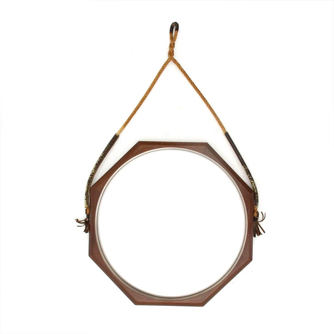 Italian manufacture mirror produced in the 1960s.
Octagonal wooden frame.
Mirrored glass surface.
Brass hooks.
Fabric rope with leather details.
Good general conditions, some signs due to normal use over time.

Dimensions: Width 58 cm, height