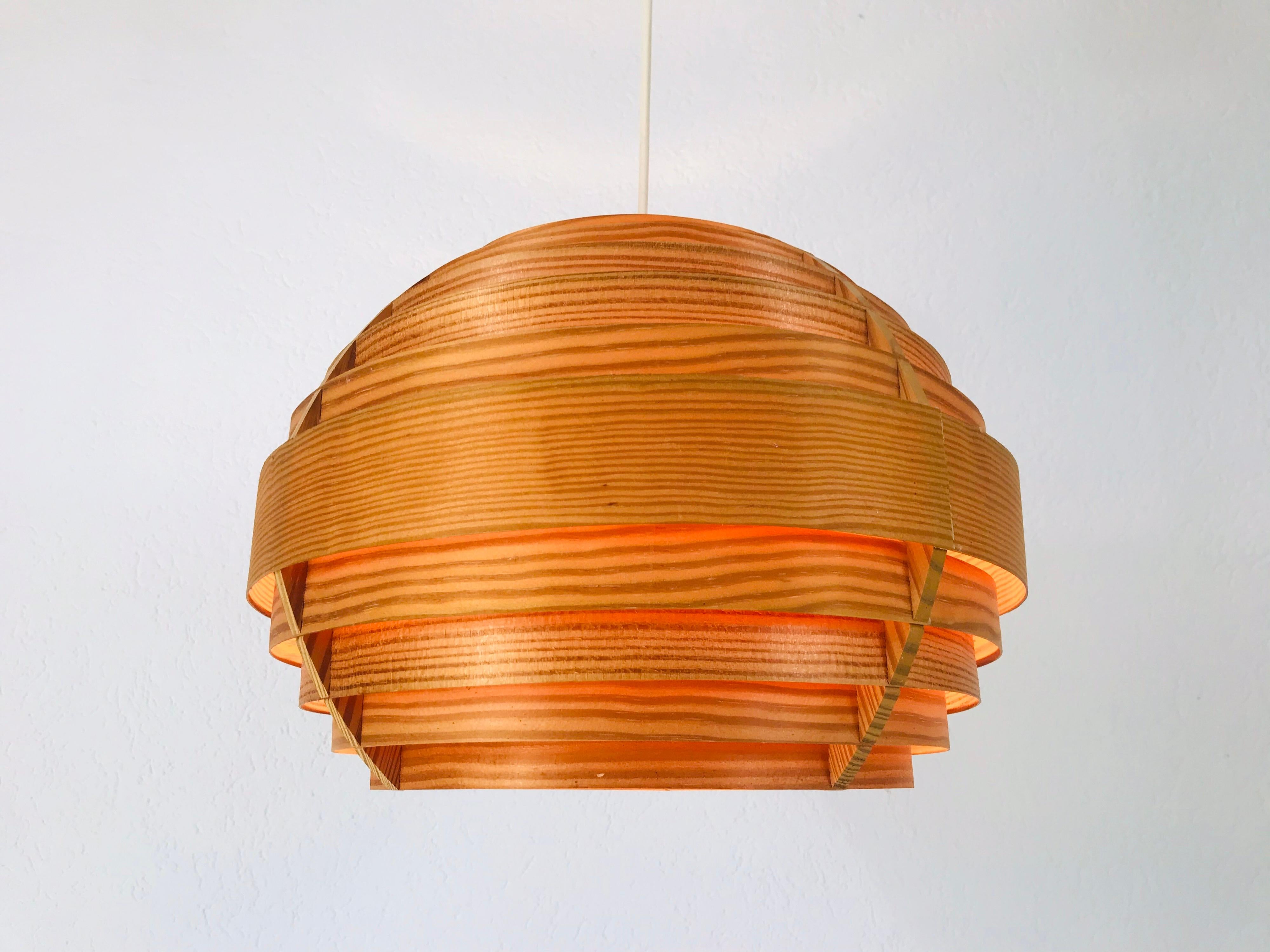 A wooden pendant lamp by Hans-Agne Jakobsson made in the 1960s. The body of the lamp is wood. The lamp has a beautiful Scandinavian design.

Measurements of the shade:
Height 30 cm
Diameter 37 cm

Total height
70 cm

The light requires an