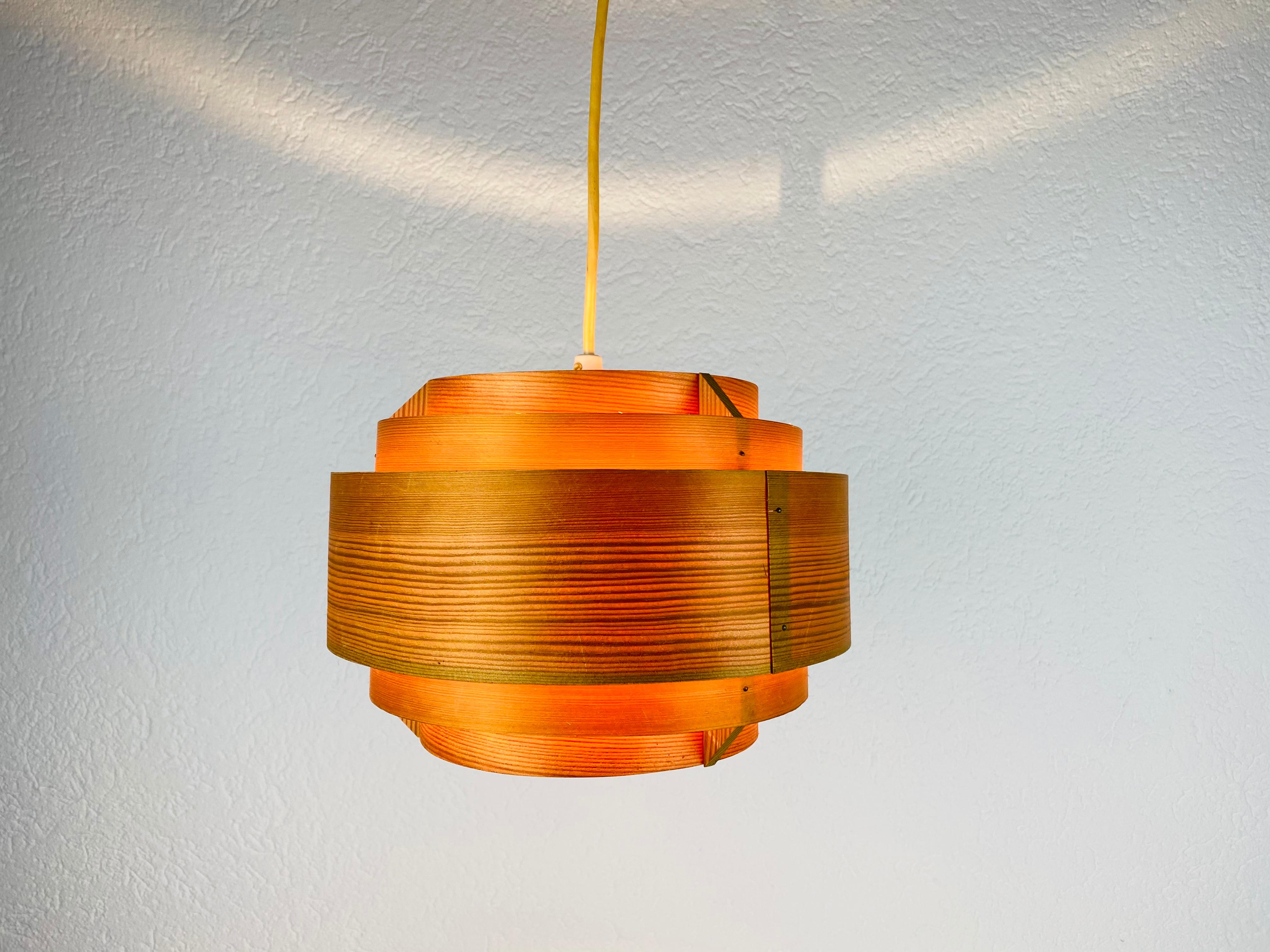 A wooden pendant lamp by Hans-Agne Jakobsson made in the 1960s. The body of the lamp is wood. The lamp has a beautiful Scandinavian design.

Measurements of the shade:
Height 18 cm
Diameter 25 cm

Total height
46 cm

The light requires an