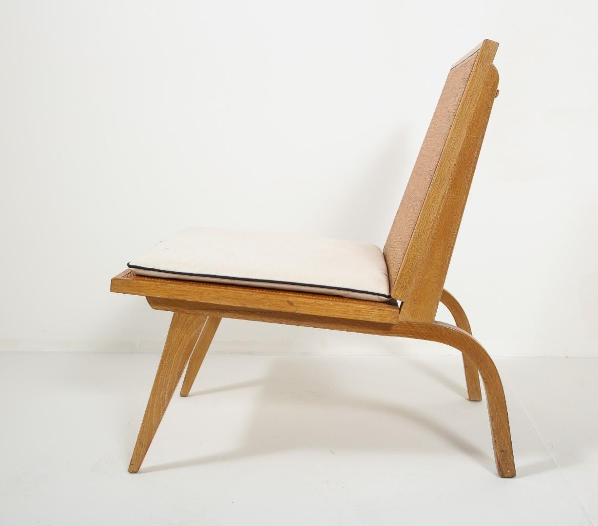 Midcentury oak and cane lounge chair by American architect Edward Durell Stone, manufactured by Fulbright Furniture, 1945. Custom ivory seat cushion with black welting. 

literature: Edward Durell Stone: Evolution of an Architect, Durell Stone,