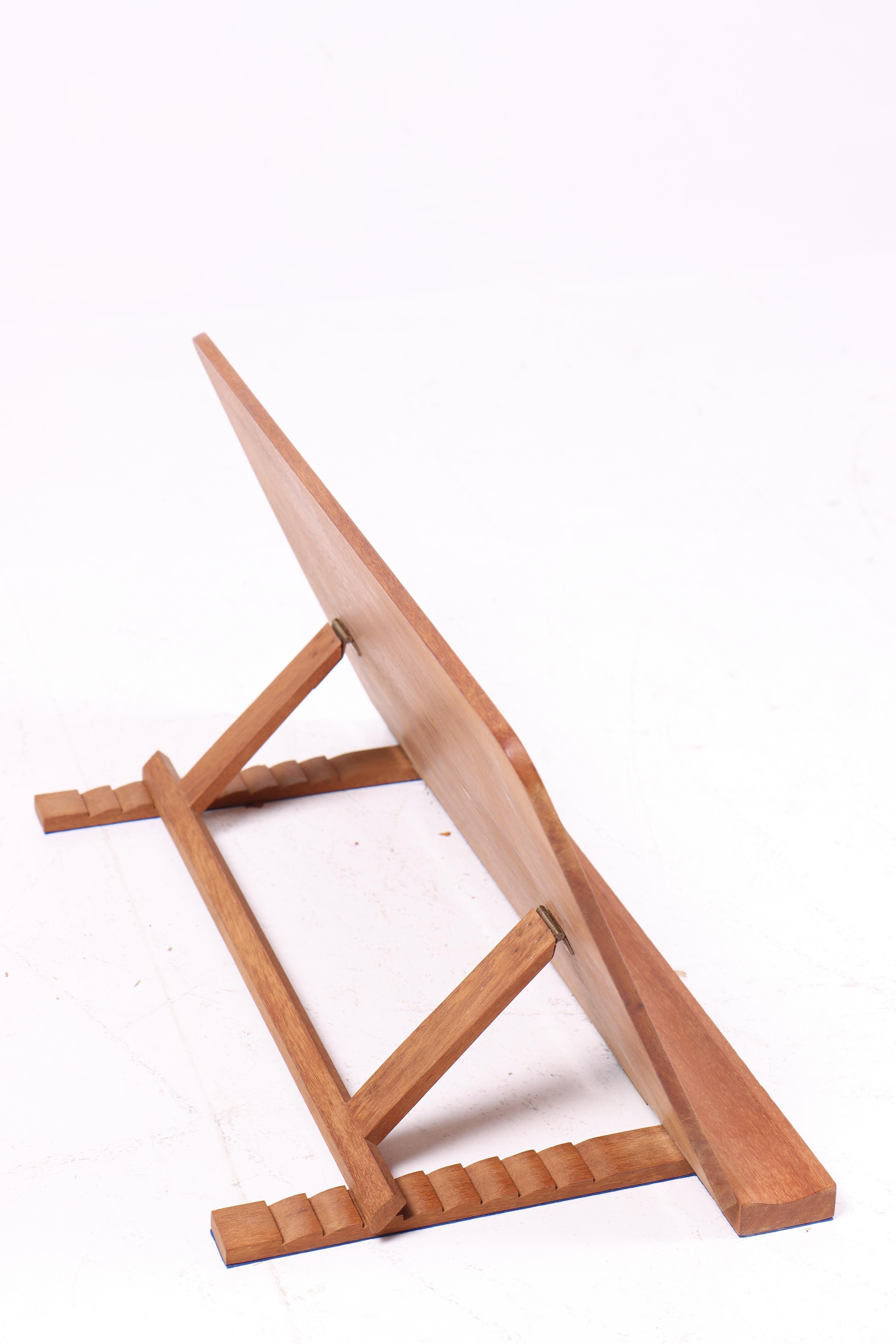 This adjustable writing desk is a perfect example of Danish craftsmanship and design. The solid teak construction ensures long-lasting durability, while the adjustable design provides flexibility for various uses. Whether used as a writing desk or