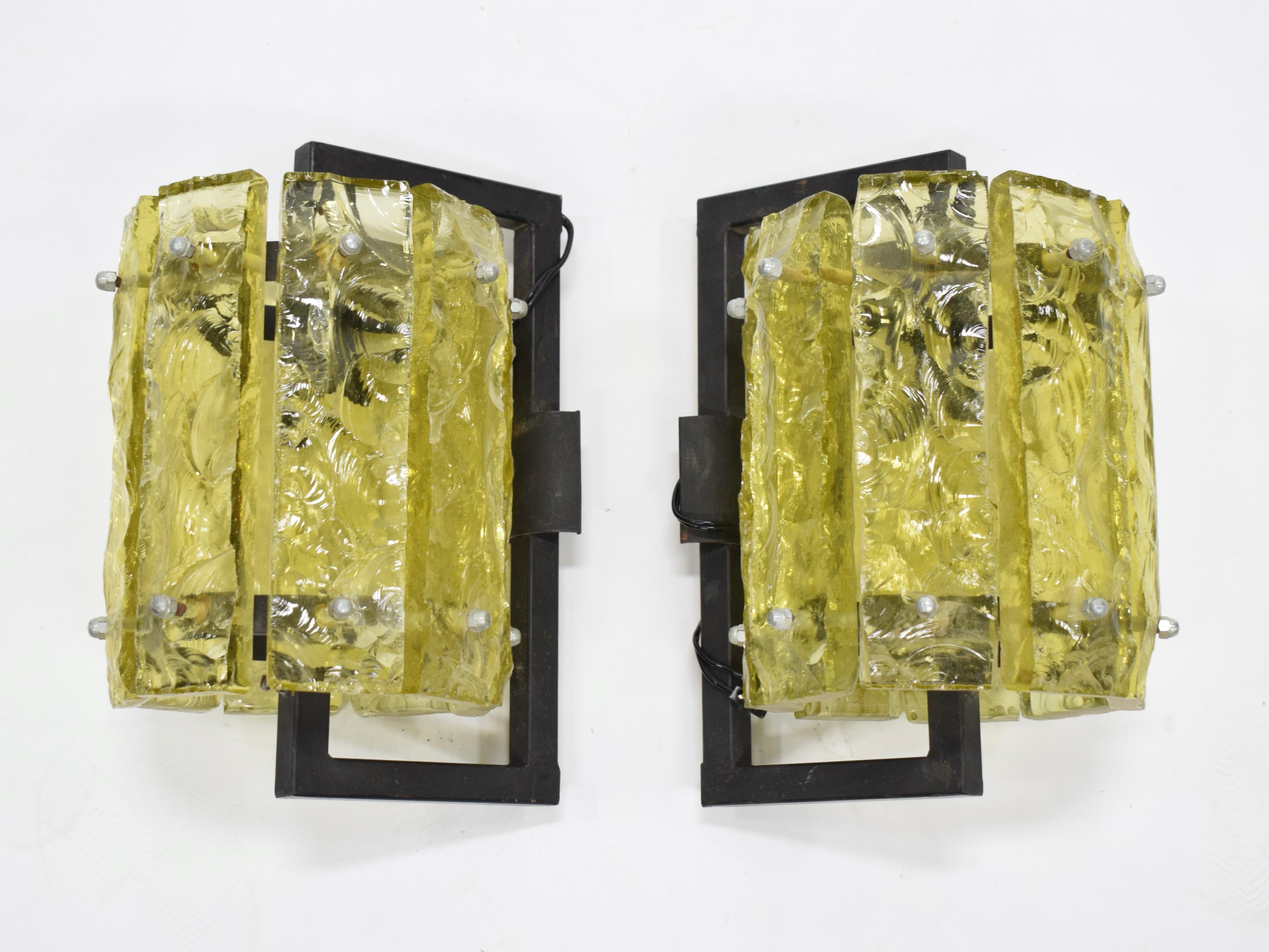 Midcentury sconces featuring wavy yellow glass and black metal frames. Newly rewired for US electrical. 