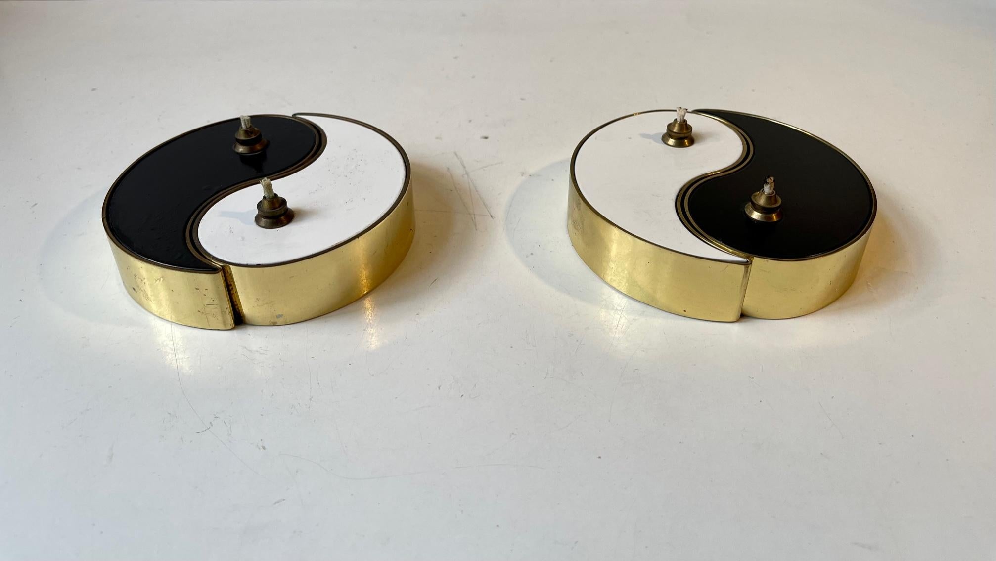 2x2 Oil lamps intervened in shape of an Ying & Yang symbol composed of brass and white and black enamel. Manufactured by G.V. Harnisch Eftf. in Denmark during the 1960s. Design number: 002697. Fully engraved/stamped to the bottom. Please do notice