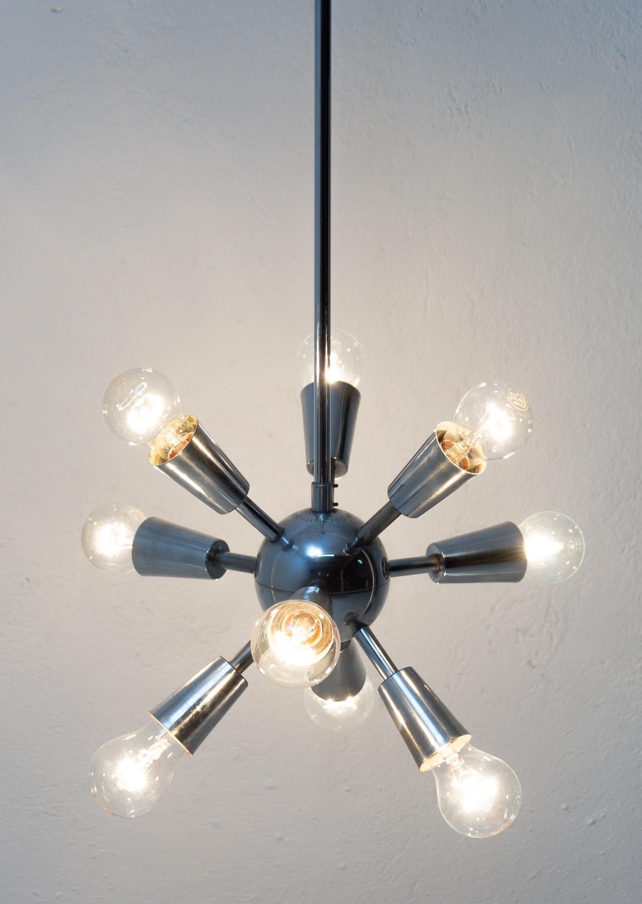This Space Age Sputnik chandelier was made in the former Czechoslovakia by Drupol company in the 1960s. It features 10 chromed arms with E27 bulb socket. The chandelier is in very good vintage condition just bears a minor signs of age and using. It