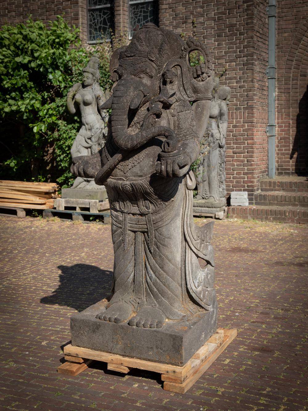 The large and special lavastone Ganesha statue is a truly magnificent and sacred artifact originating from Indonesia. Crafted from lavastone, this Ganesha statue stands tall at an impressive height of 175 cm and measures 67.5 cm in width and 55 cm