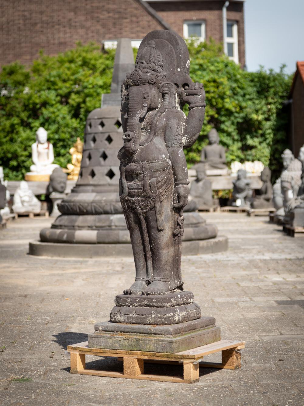 The large old lavastone Ganesha statue is a truly magnificent and spiritually significant artifact originating from Indonesia. Crafted from lavastone, this Ganesha statue stands tall at an impressive height of 162 cm and measures 53 cm in width and