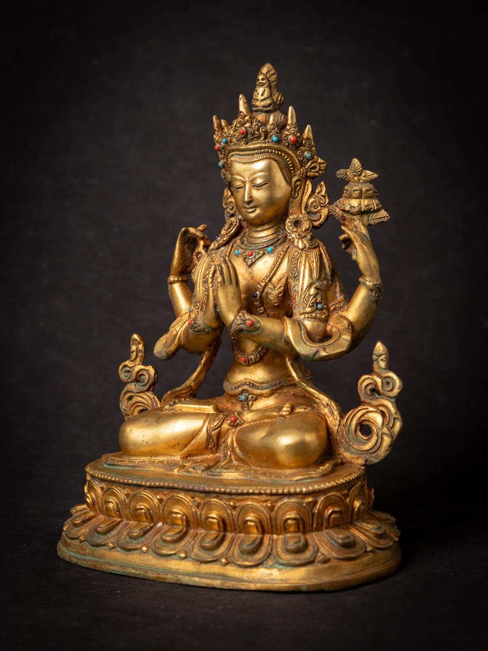 This old bronze Chenrezig statue from Nepal is a remarkable piece of religious artistry. Crafted from bronze and adorned with intricate fire gilding, it stands at a height of 23.2 cm, with dimensions of 16.5 cm in width and 12.3 cm in depth.