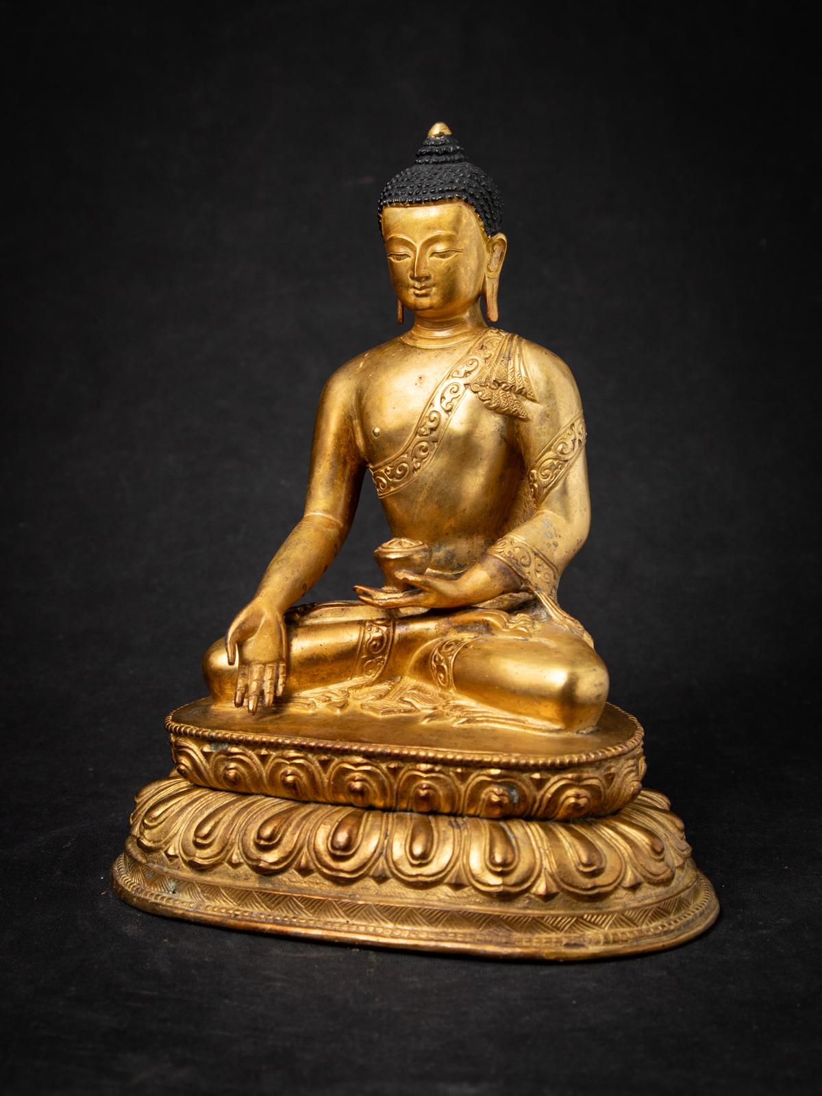 Cette statue de Bouddha népalais en bronze ancien est un véritable chef-d'œuvre d'artisanat et de spiritualité. D'une hauteur majestueuse de 24 cm, avec des dimensions de 19,8 cm en largeur et 14,6 cm en profondeur, il s'agit d'une représentation