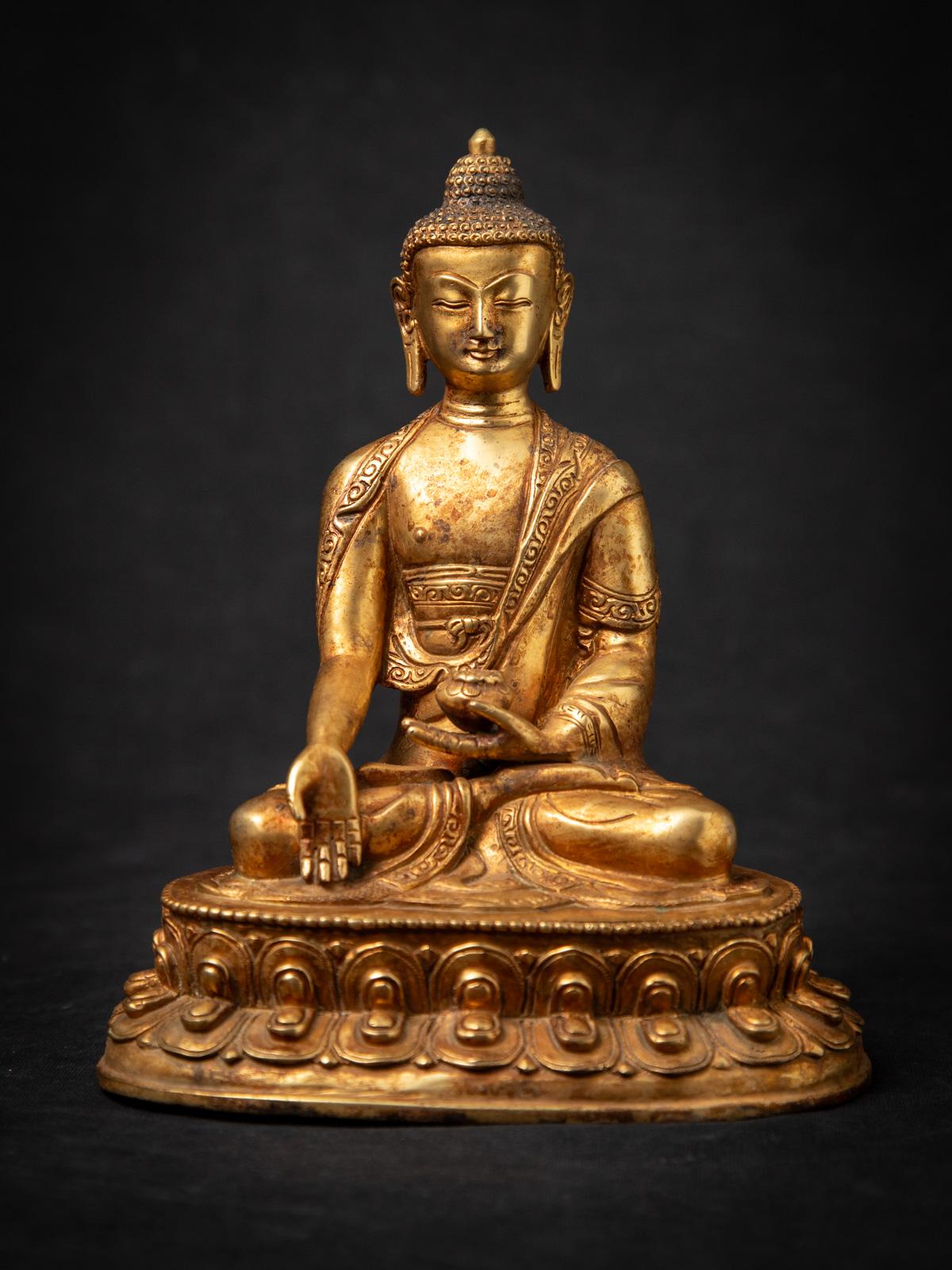 Diese alte nepalesische Buddha-Statue aus Bronze aus der Mitte des 20. Jahrhunderts ist ein schönes Beispiel für die buddhistische Kunst des Himalaya. Gefertigt aus Bronze und feuervergoldet mit 24 krt. Gold, misst die Statue 21,1 cm hoch, 17,2 cm