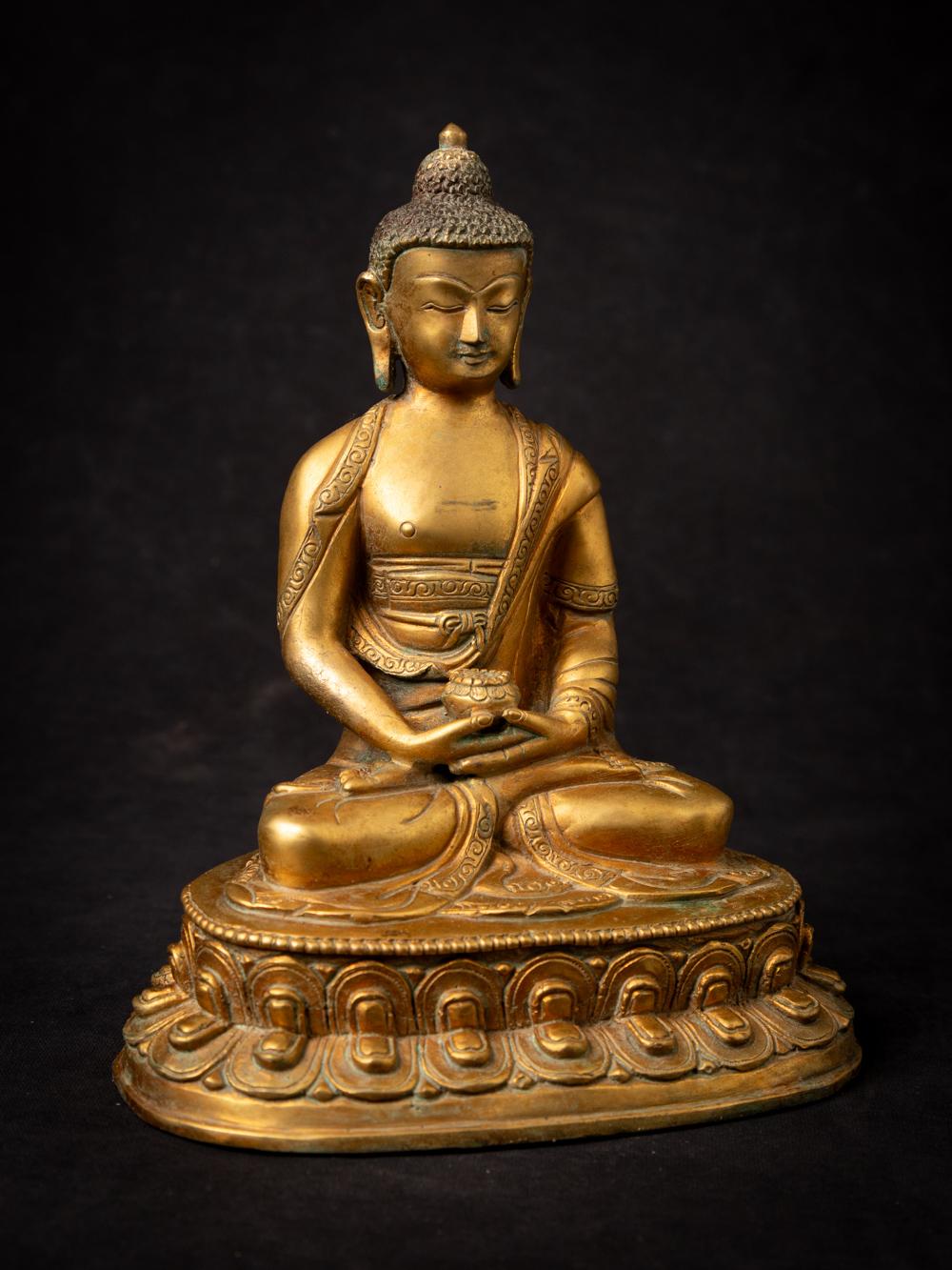 This Old bronze Nepali Buddha statue is a true masterpiece of craftsmanship and spirituality. Standing at a majestic 21.5 cm in height, with dimensions of 17.5 cm in width and 12.9 cm in depth, it is a substantial representation of the Buddha.

The