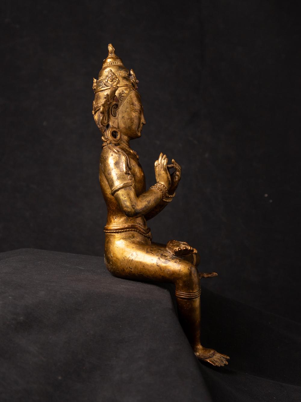 Cette statue de bodhisattva népalais en bronze ancien est une représentation exquise d'une figure vénérée du bouddhisme tibétain. Fabriquée en bronze, elle mesure 30 cm de haut pour 10,7 cm de large et 10 cm de profondeur, ce qui en fait une œuvre