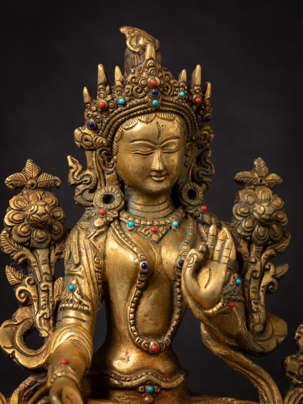 This Old bronze Nepali Aparmita Buddha statue is a remarkable piece of art that reflects the rich cultural and religious traditions of Nepal. Crafted from bronze and fire-gilded with 24-karat gold, this statue stands at a height of 21,9 cm, with