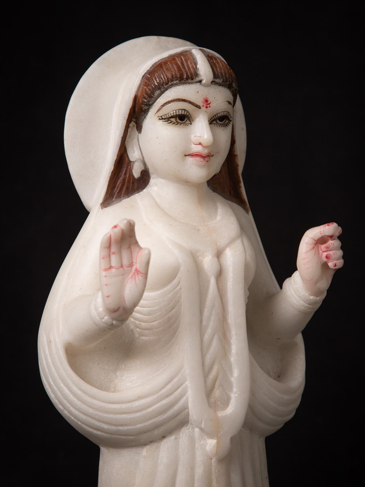 This Old Indian marble Khodiyar mata statue is a Middle 20th century piece originating from India. Crafted from a single block of white marble, it showcases the skillful artistry of Indian craftsmen. Standing at a height of 37 cm, with dimensions of