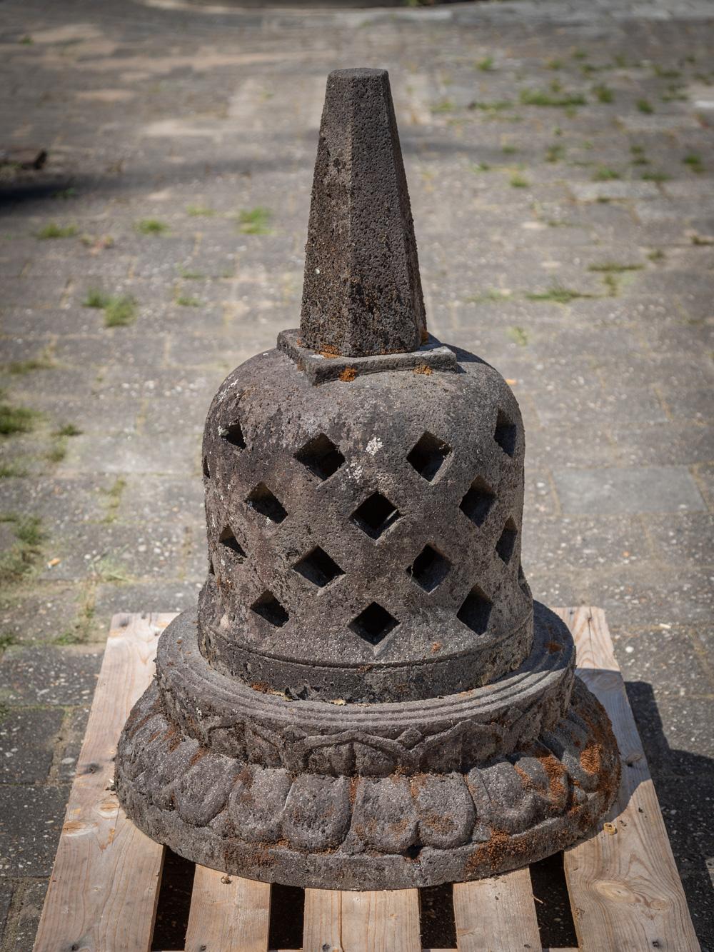The old lavastone Stupa is a magnificent and sacred artifact originating from Indonesia. Crafted from lavastone, this Stupa stands tall at 99 cm in height and has a diameter of 70 cm. Estimated to weigh approximately 150 kg, it carries a substantial