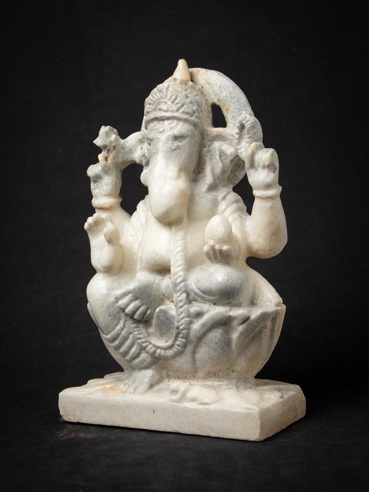 This Old marble Ganesha statue is a magnificent work of art that embodies the essence of the elephant-headed deity, Lord Ganesha. Crafted from marble, it stands 29,8 cm tall, with dimensions of 18,8 cm in width and 8,8 cm in depth. Despite being