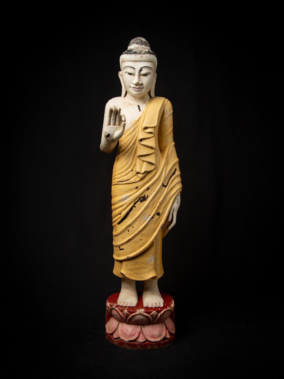 Presenting this old wooden Burmese Buddha statue, a striking middle 20th-century piece crafted in the refined Mandalay style. Expertly carved from wood, it features the Vitarka mudra, symbolizing the gesture of teaching and discussion of Buddhist