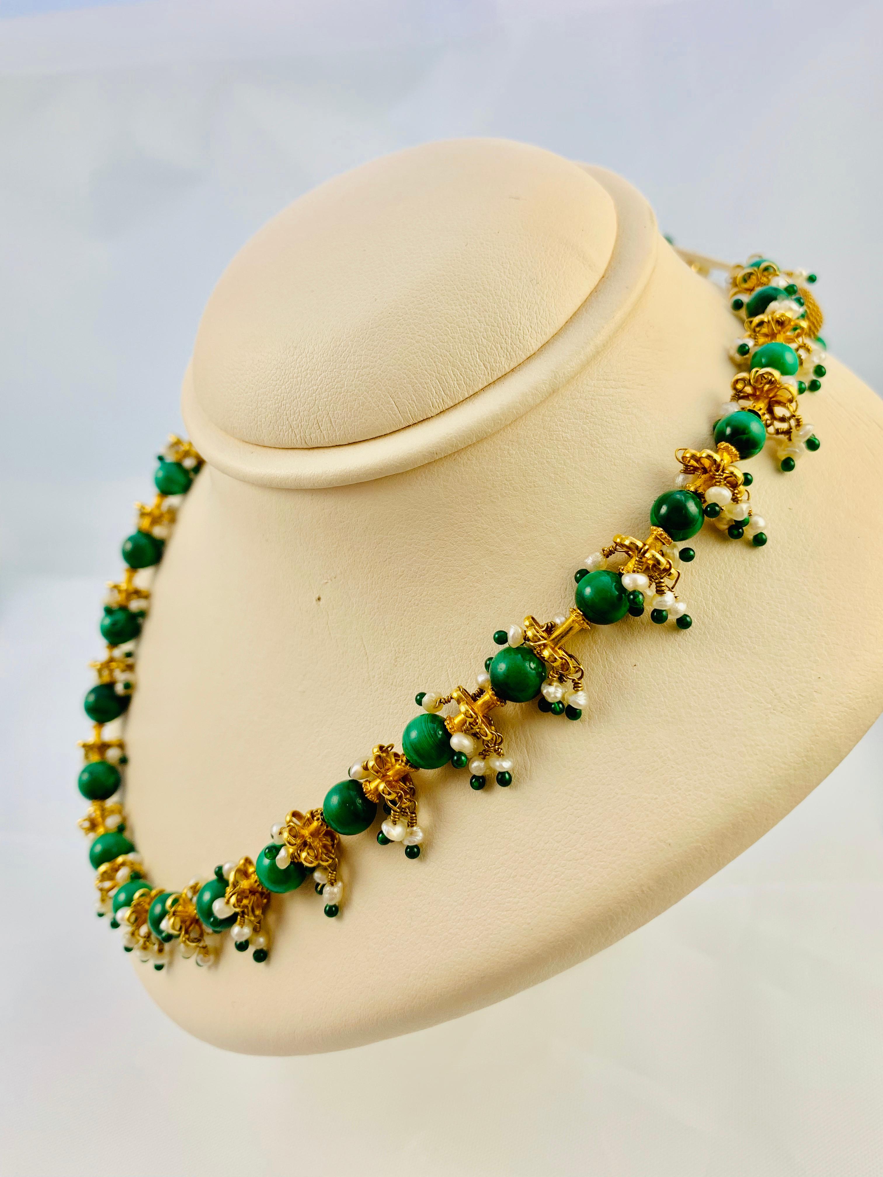 This necklace is an absolute show stopper! Middle Eastern Styled that features 32, 6.6 mm   
Malachite Beads that are separated by stunning 22K Yellow Gold floral themed stations with pearl and emerald dangles. It is 18 inches long and weighs 47.0
