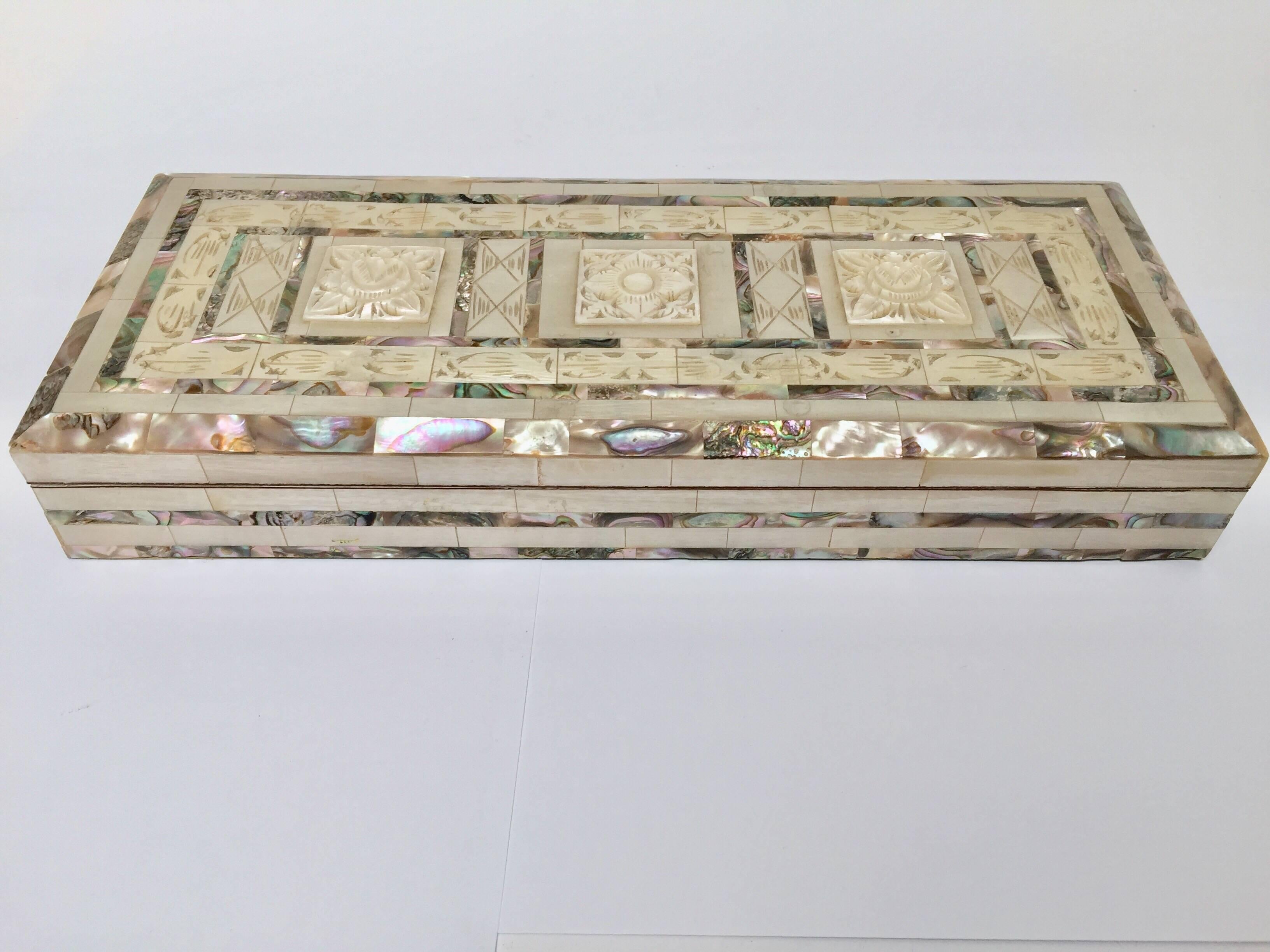 Middle Easter beautiful decorative rectangular box covered in abalone and hand-carved mother-of-pearl inlaid. 
Measures: Height 2 inches, length 12 inches x 5 inches wide. 
The box is lined in green velvet.
Islamic Folk Art, museum quality collector
