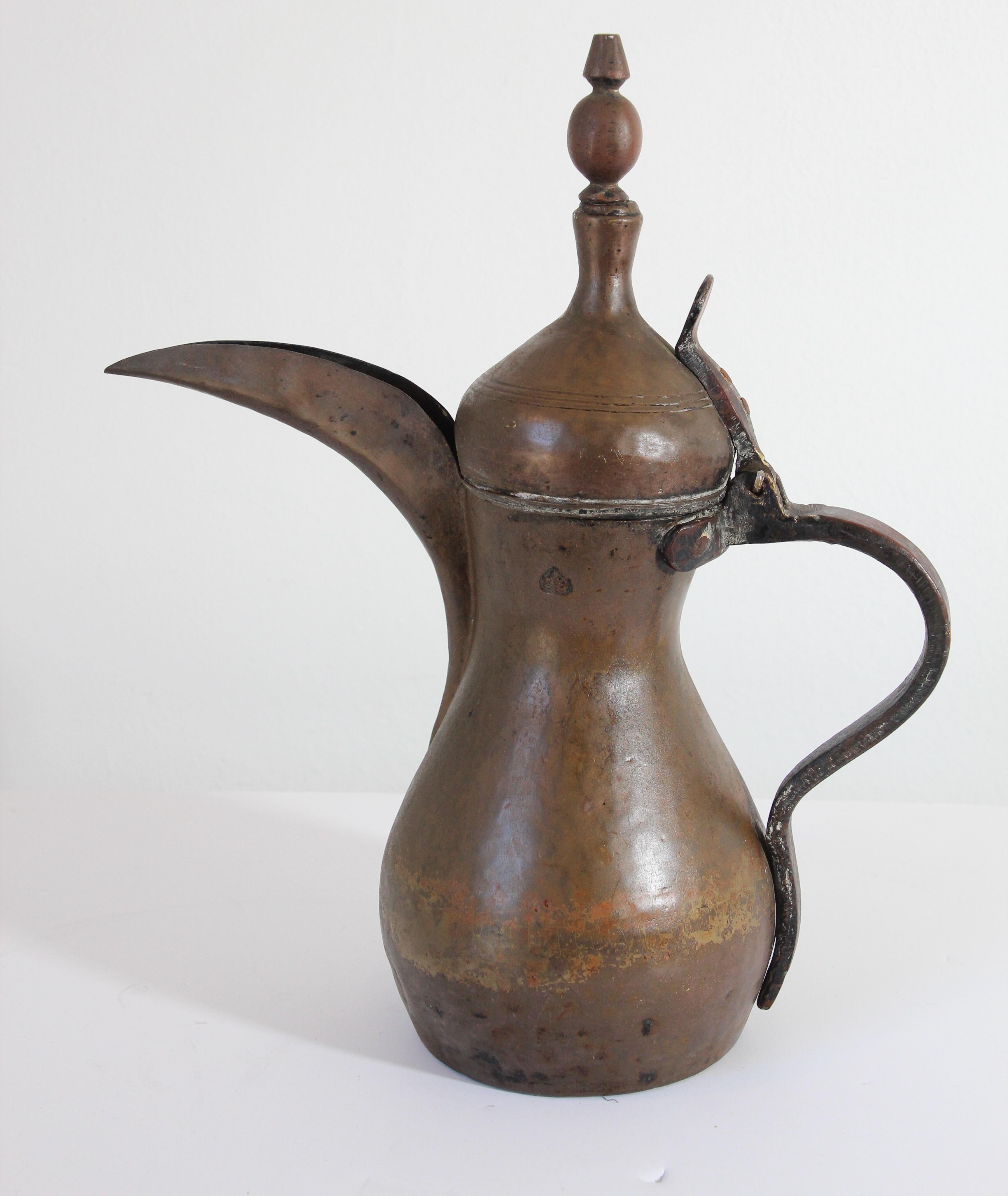 19th century Middle Eastern traditional Arabian tinned copper and brass Dallah coffee pot. 
Coffee pot hand-hammered and chased copper with riveted brass finish and a very large spout. 
Size: 16