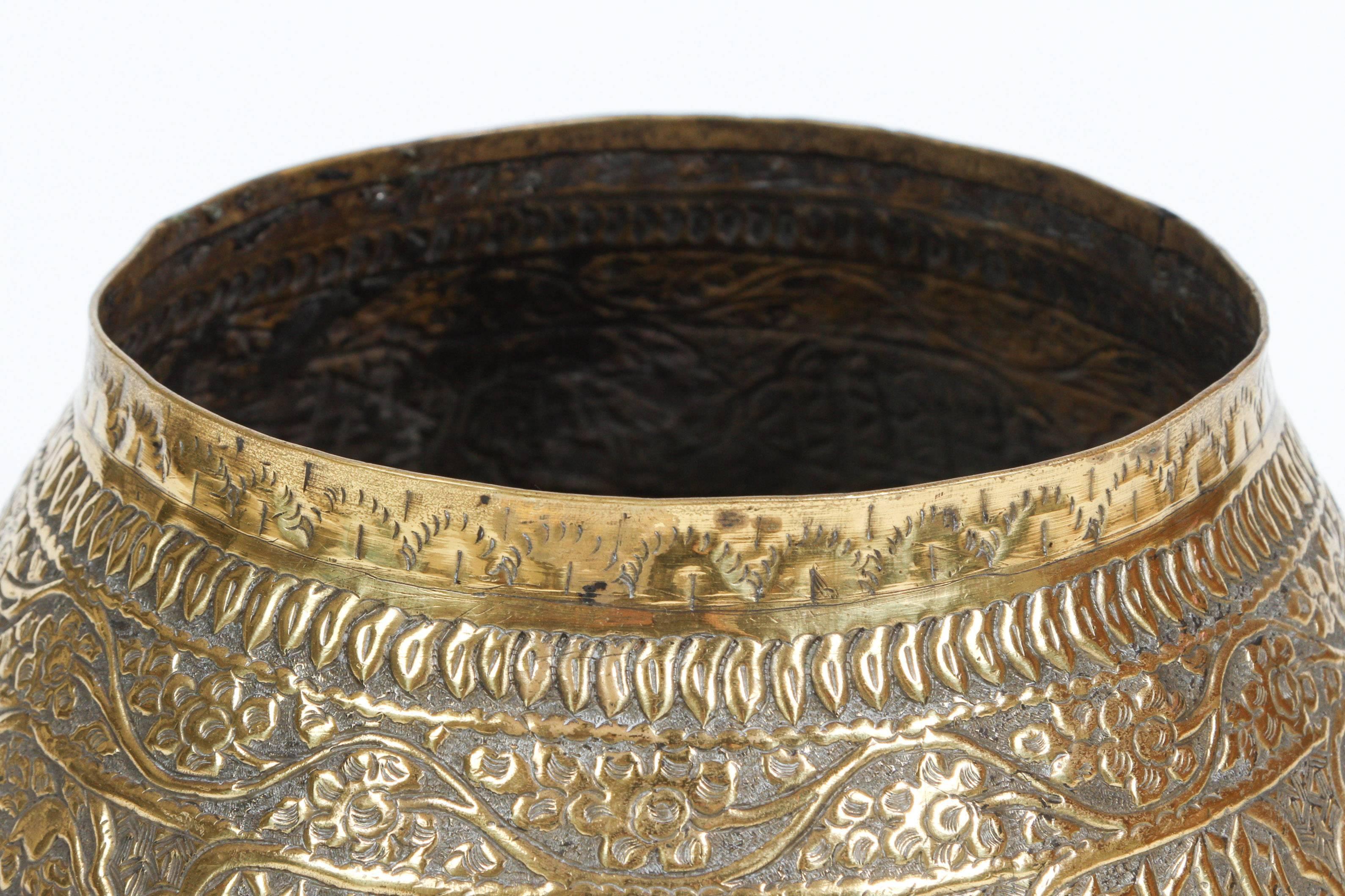 Large antique 19th century or before brass Middle Eastern Persian Islamic style footed bowl finely and heavily hand-etched and embossed with brass repousse and decorated with calligraphic decoration inscriptions medallions.
A large Mamluk style