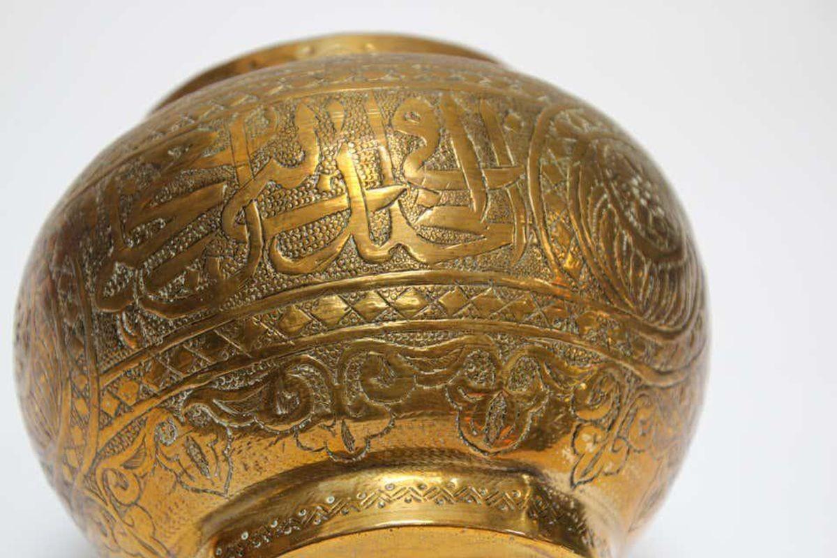 Small metal brass Middle Eastern Egyptian Islamic magic bowl hand-etched and hammered with Moorish designs repoussé. Early 20th century Islamic brass vessel bowl. Engraved and hand-chased with Kufic Arabic writing and geometric Egyptian arabesque