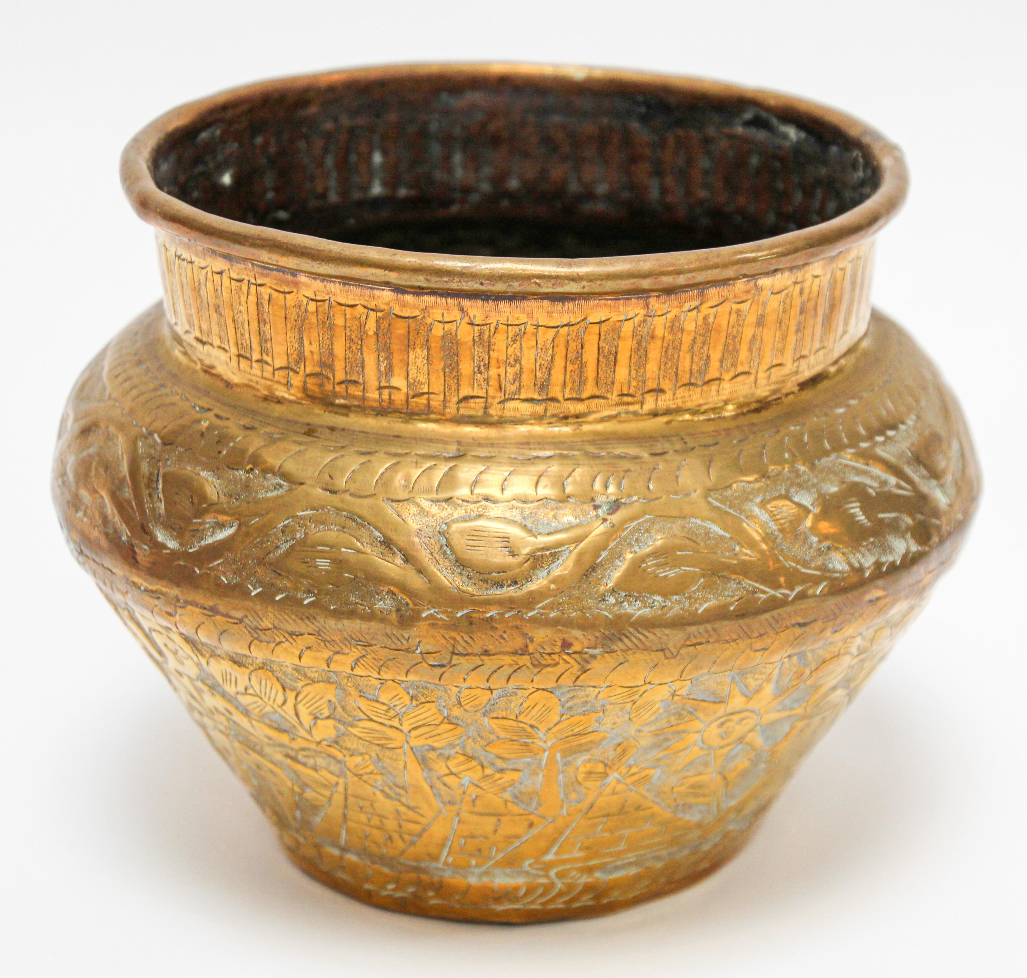 Middle Eastern Islamic Egyptian metal bowl hand-etched and hammered brass.
Early 20th century Egyptian Arabian brass vessel bowl.
Engraved and hand-chased repousse with Egyptian arabesque designs on brass vessel.
Egyptian pyramids, birds and