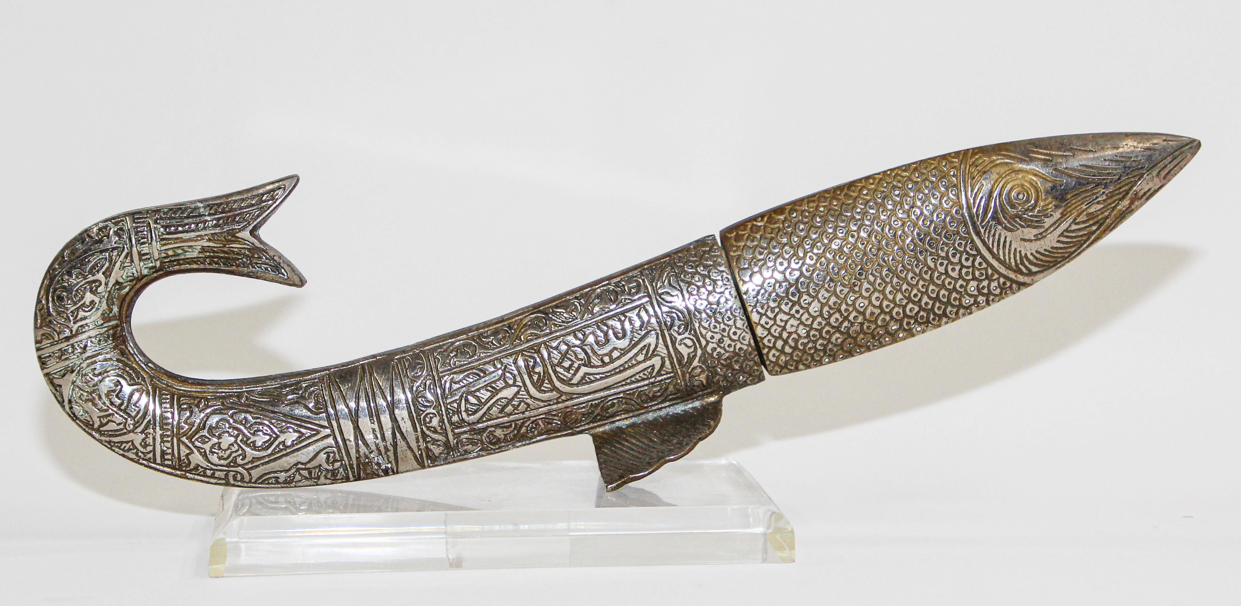 Middle Eastern handcrafted dagger in the form of a fish with Arabic calligraphy writing.
Great vintage silver plate metal dagger letter opener in a form of a fish dagger.
Great decorative collector dagger, metal brass silvered with hand chased