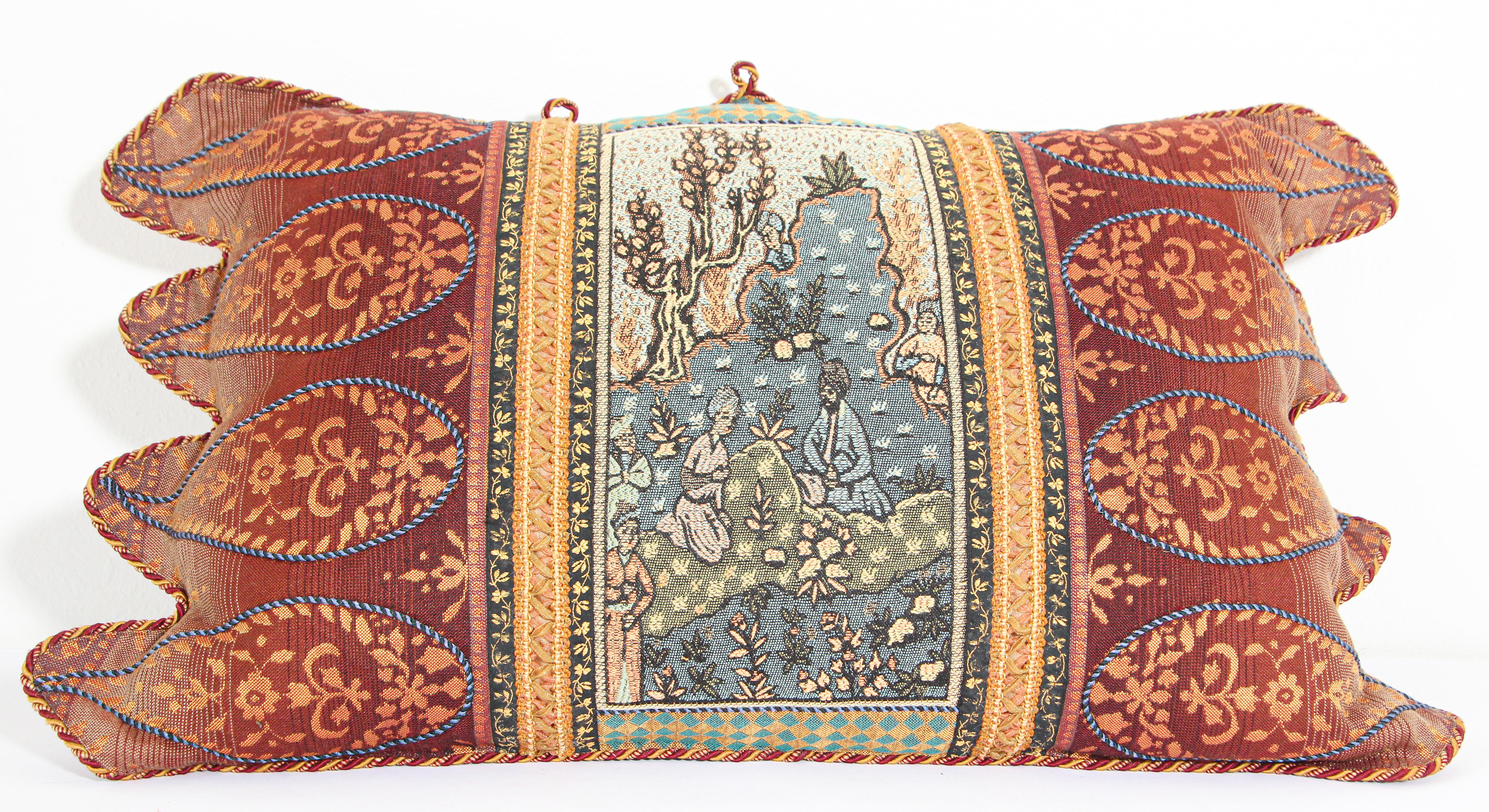 Middle Eastern decorative throw pillow and tapestry.
Luxury silk in beige with an accent textile fragment with a Middle Eastern scene and decorative silk trim has been applied to finish the edges.