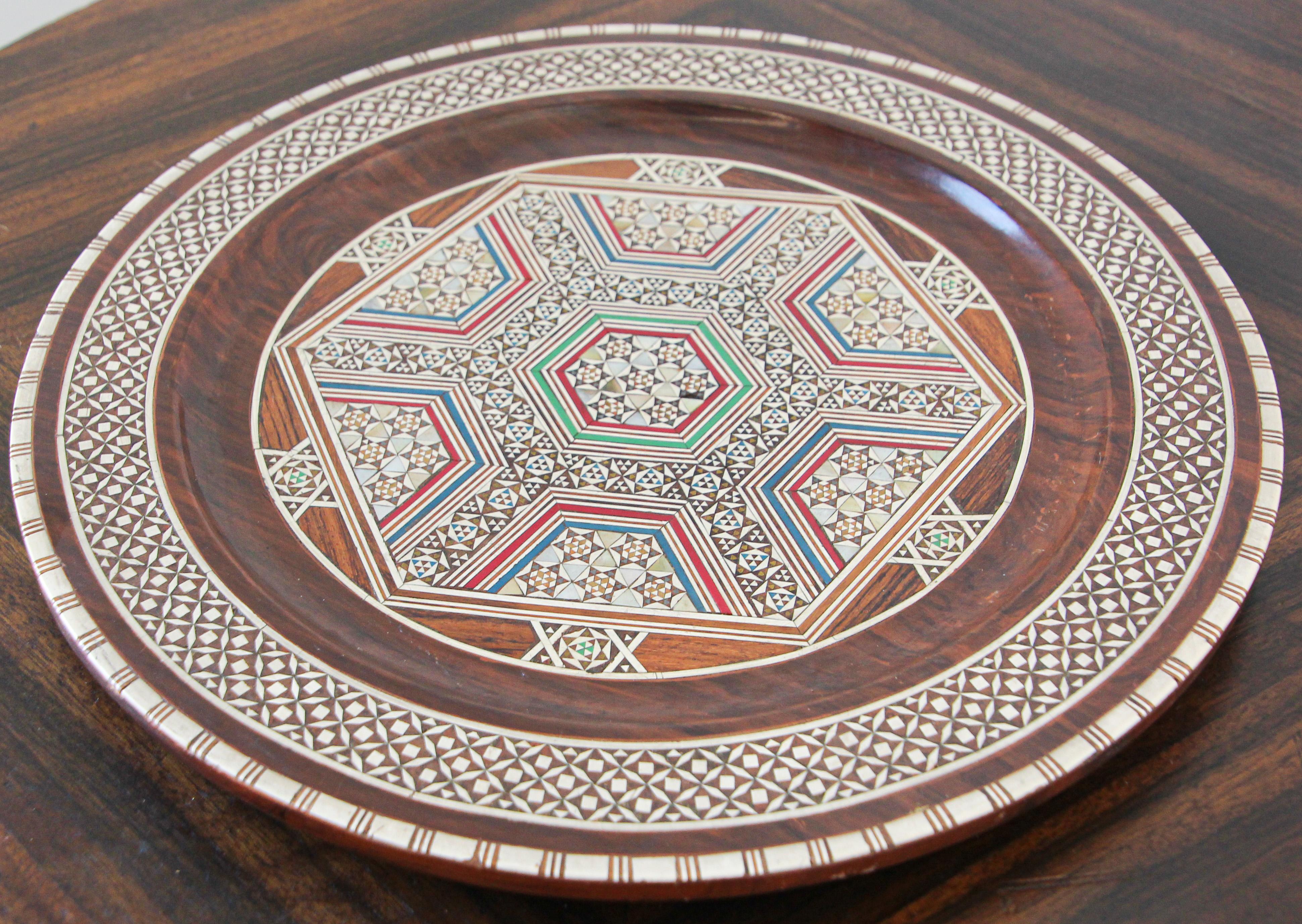 Middle Eastern Moorish decorative plate inlaid with mosaic marquetry.
This beautiful wooden plate with elaborate mosaic marquetry inlay is from Cairo, Egypt.
Great Egyptian style mosaic inlay mosaic marquetry wood decorative serving tray or