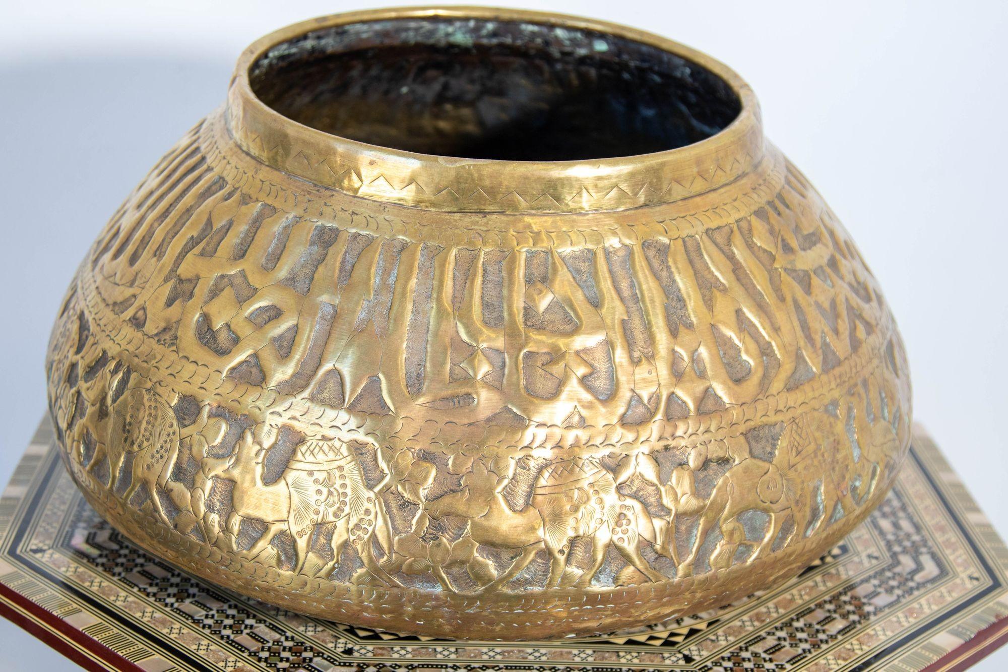 Antique large Middle Eastern Egyptian hand-etched and repousse Mameluke style brass bowl.
Could be used as a jardinière, cache pot for a large orchids composition.
Engraved and hand-embossed with Arabic Islamic Tuluth writing calligraphy and