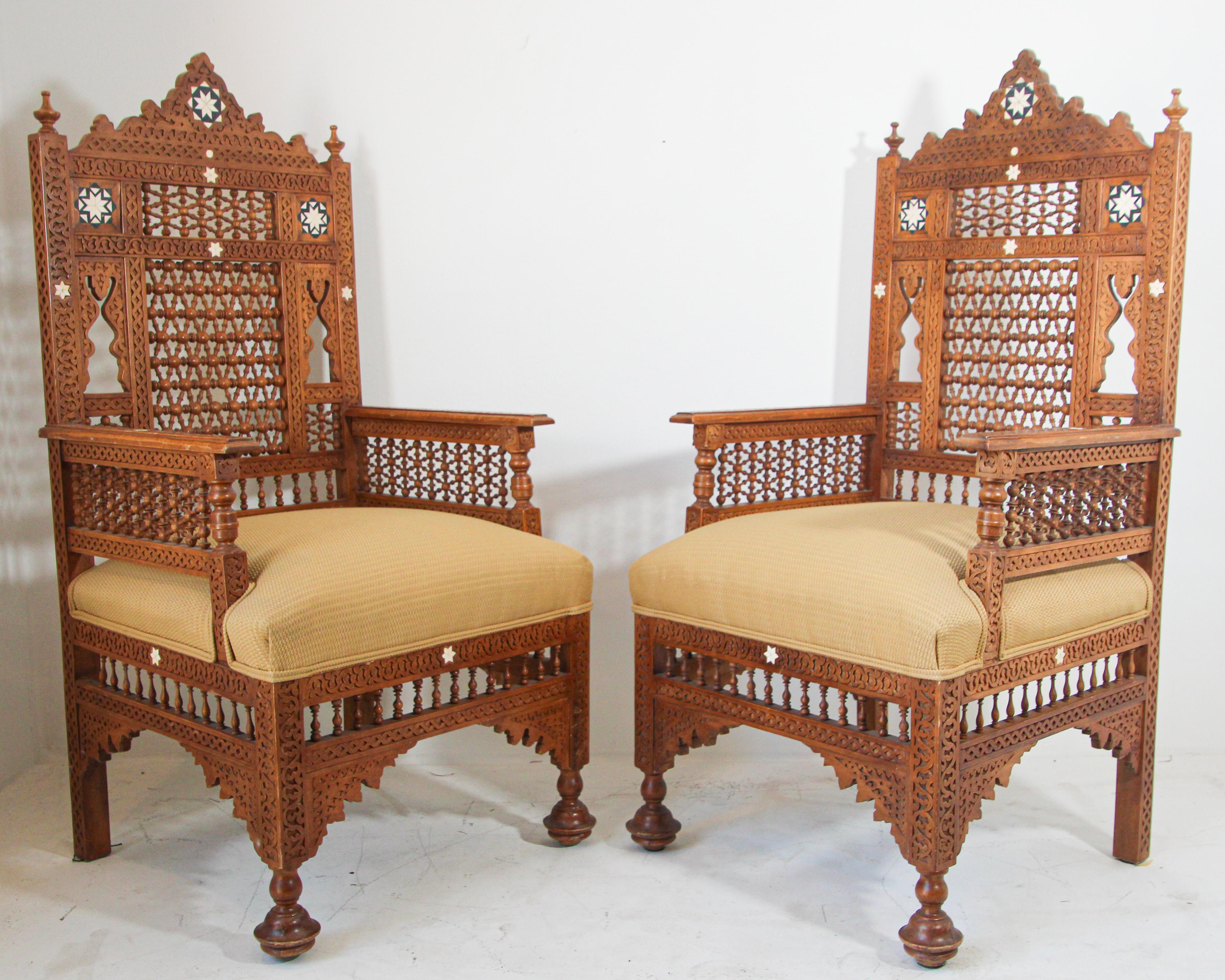 Middle Eastern Egyptian Moorish Royal Throne Armchairs.Large-scale set of two Moorish armchairs, Middle Eastern Arabian style, finely hand-carved.Nice moucharabie designs all-over the chair, newly upholstered with gold Moroccan fabric.Very Fine