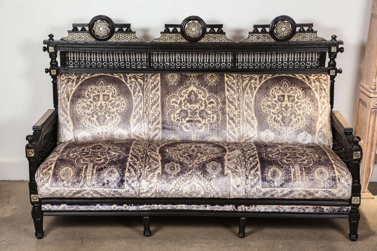 Middle Eastern Egyptian black settee with spindle and ball design with triple Moorish arches inlaid with mucharabie intricate and Fine work.
Sofa is newly reupholstered with antique Moroccan silk fabric.
Reflect the British Colonial taste for