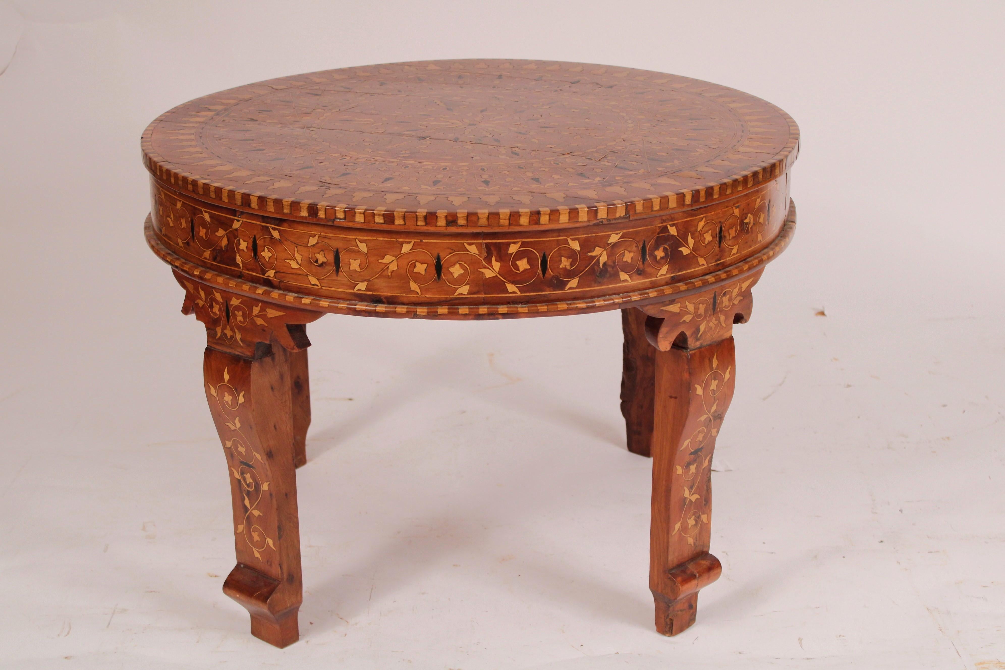 Middle Eastern round inlaid coffee table, circa 1960's. With an extensive amount of inlay on top, sides and legs.