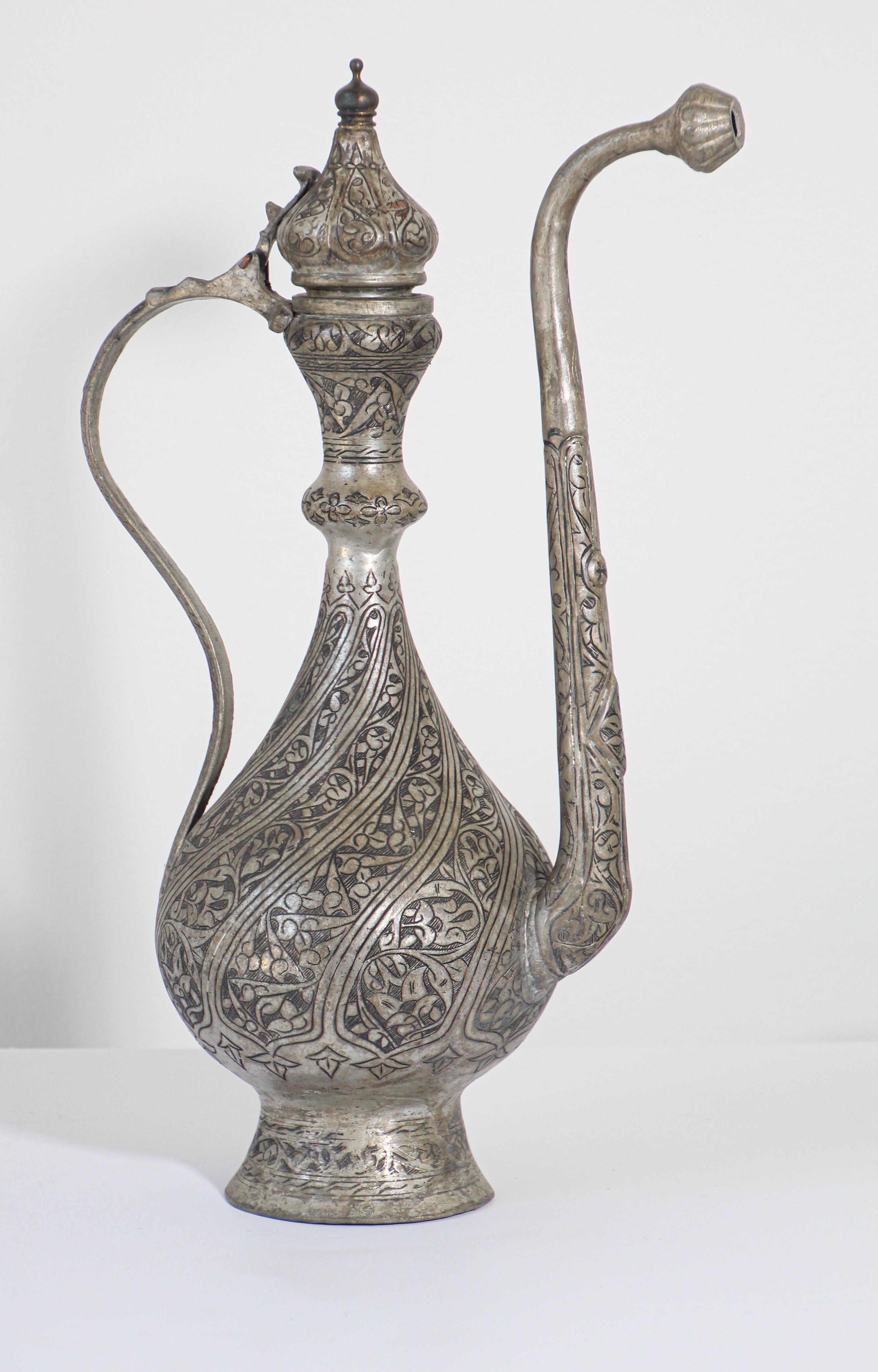Handcrafted antique 19th century Islamic Turkish Ottoman tinned copper ceremonial water ewer.
Antique Middle Eastern Asian Islamic style ewer jug metalware vessel.
The bulbous body with flared foot, long tapering neck with bulbous top and pointed