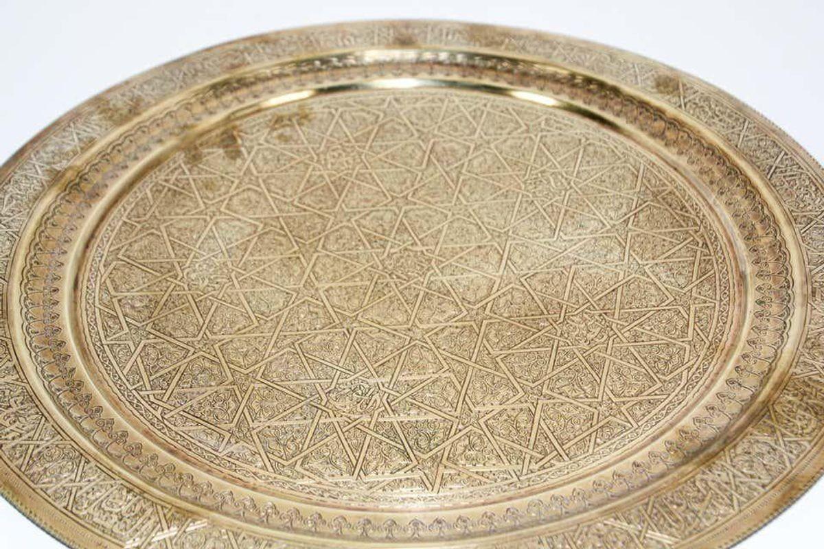 Middle Eastern Islamic Vintage round brass tray.The handcrafted circular brass platter is decorated and hammered with Islamic Moorish designs.Heavy metal brass with very fine hand chased floral and geometric Arabic calligraphy writing