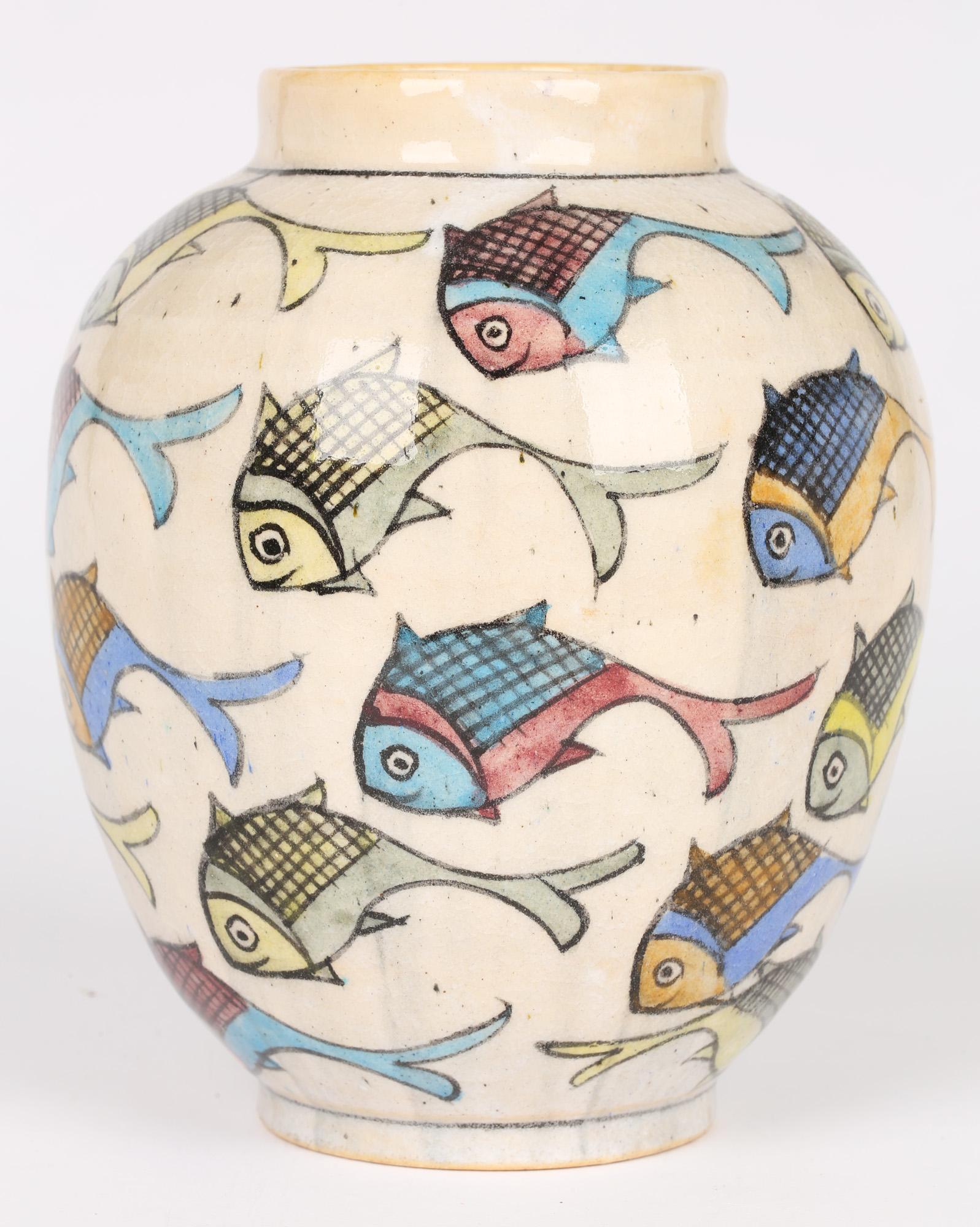 A good decorative antique Middle Eastern pottery vase painted with fish probably Iznik and dating from the early 20th century. The rounded bulbous vase stands on narrow rounded foot with a narrow funnel shape top. The body of the vase is hand