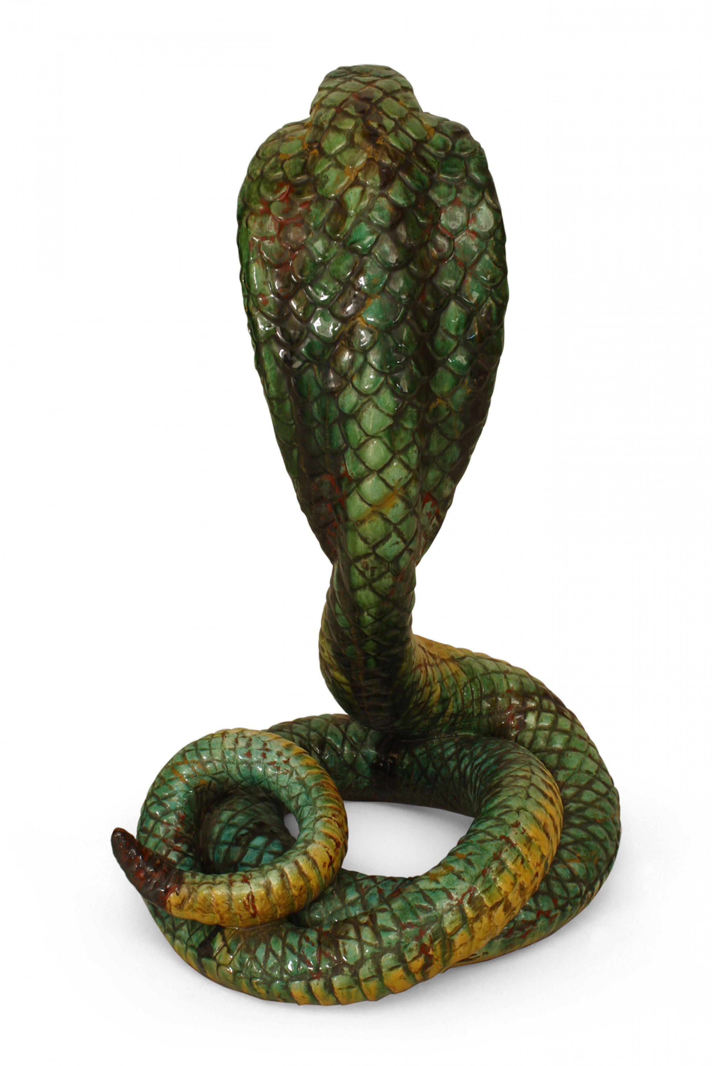 Middle Eastern Moorish style (Italian 19/20th cent) Majolica porcelain life sized green and yellow cobra, coiled with a raised head.
      