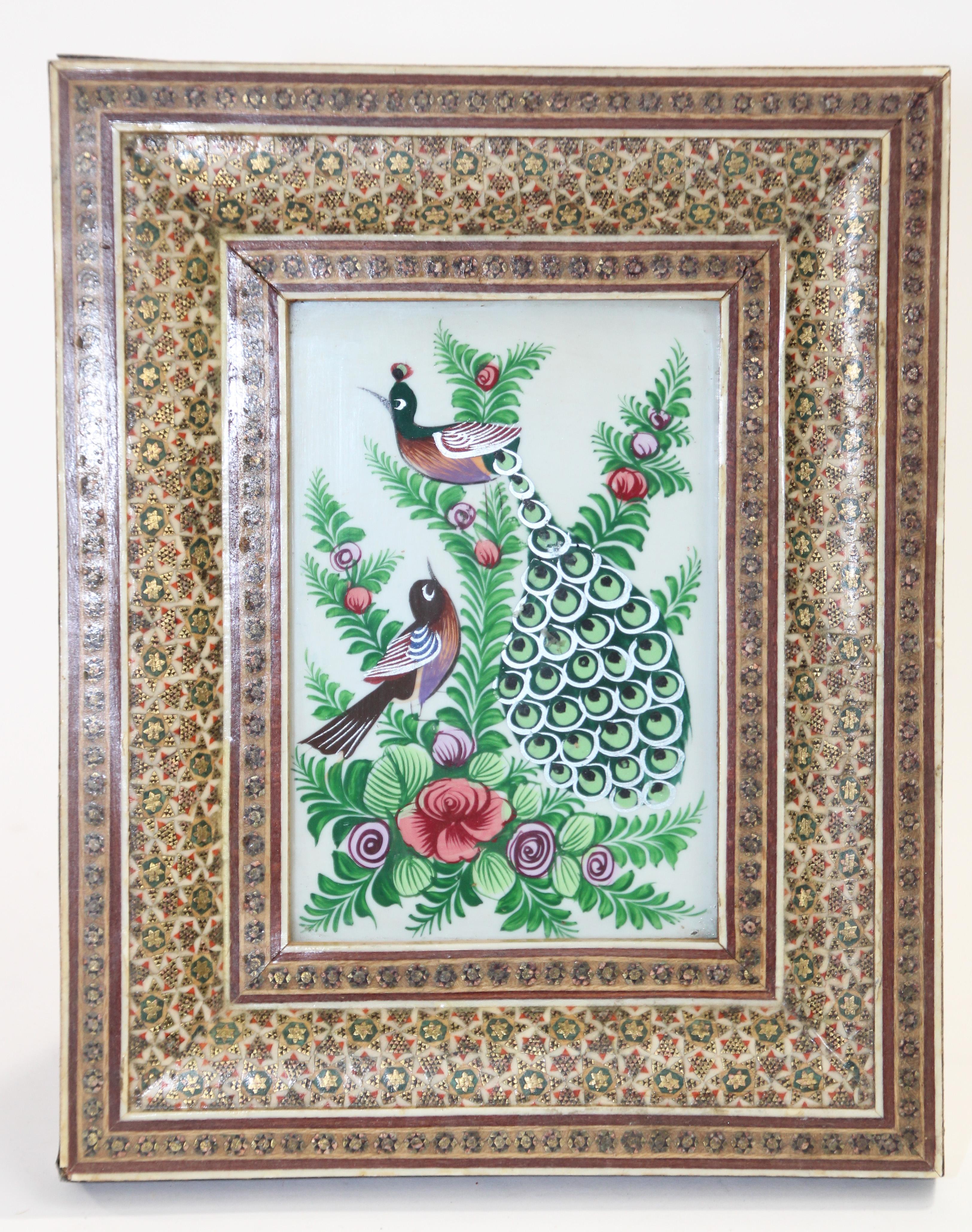 Middle Eastern miniature painting of peacocks framed in a Moorish micro mosaic inlaid picture frame.
Middle Eastern miniature painting on shell, very fine and colorful painting in an
intricate inlaid mosaic frame with floral and geometric Islamic