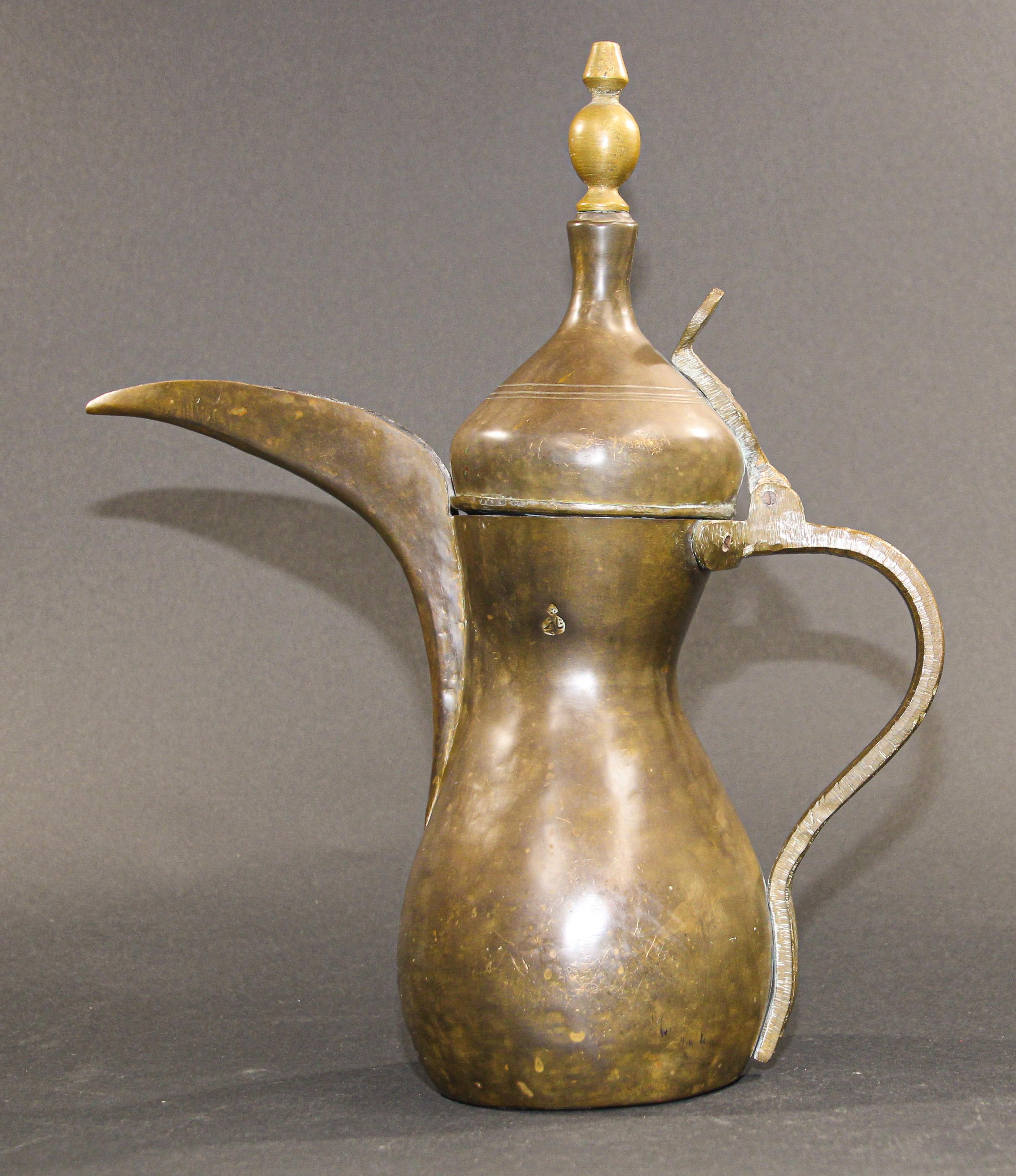 Middle Eastern traditional Arabian brass Dallah coffee pot. 
Coffee pot hand-hammered and chased copper with riveted brass finish and a very large spout. 
Size: 15