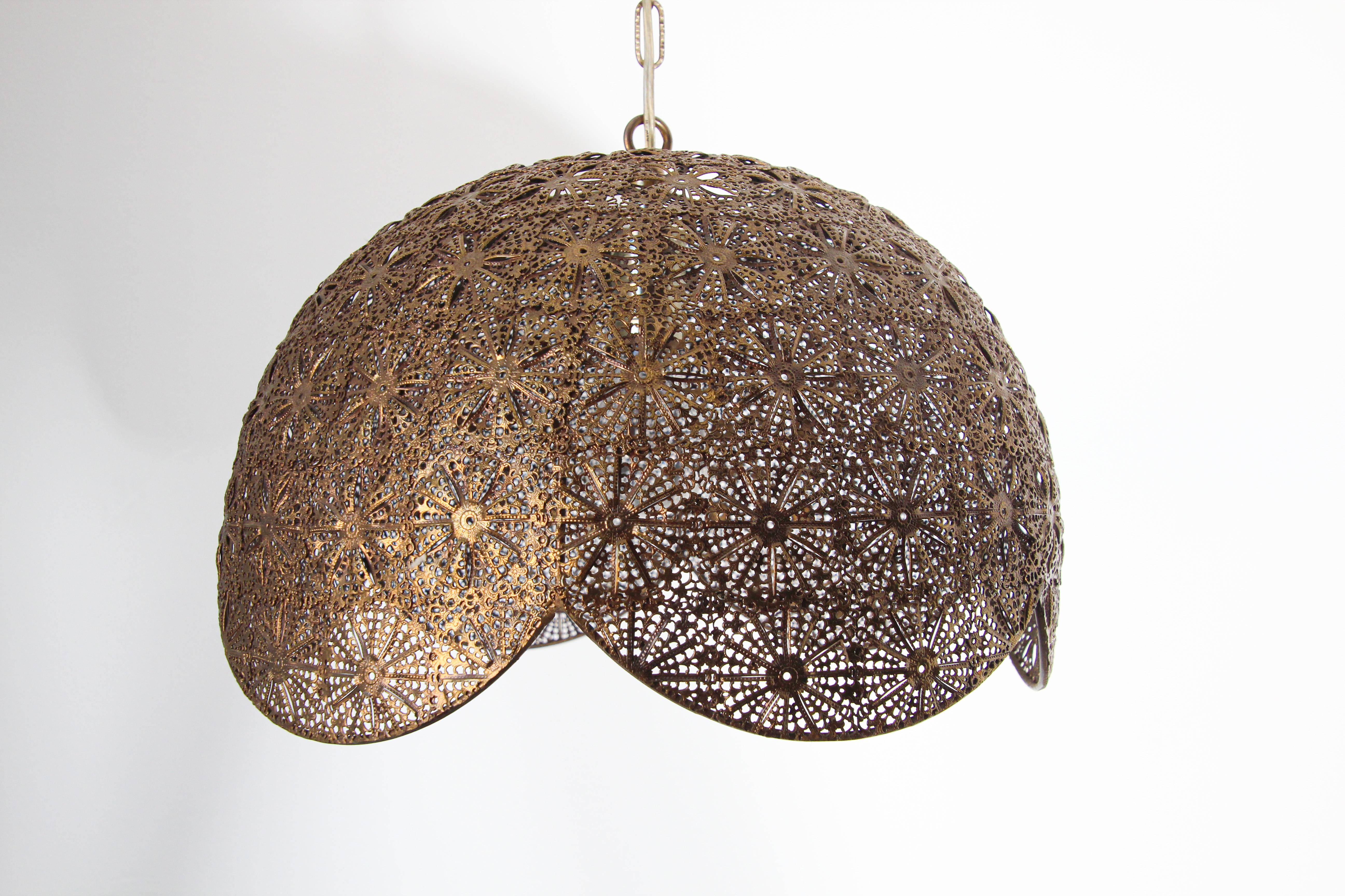 Vintage Moorish, Middle Eastern Turkish style filigree pierced brass hanging lamp. 
Unique ceiling fixture finely handcrafted in brass fine work with nice geometric Moorish filigree floral designs. Rewired for electricity with one light bulb.
