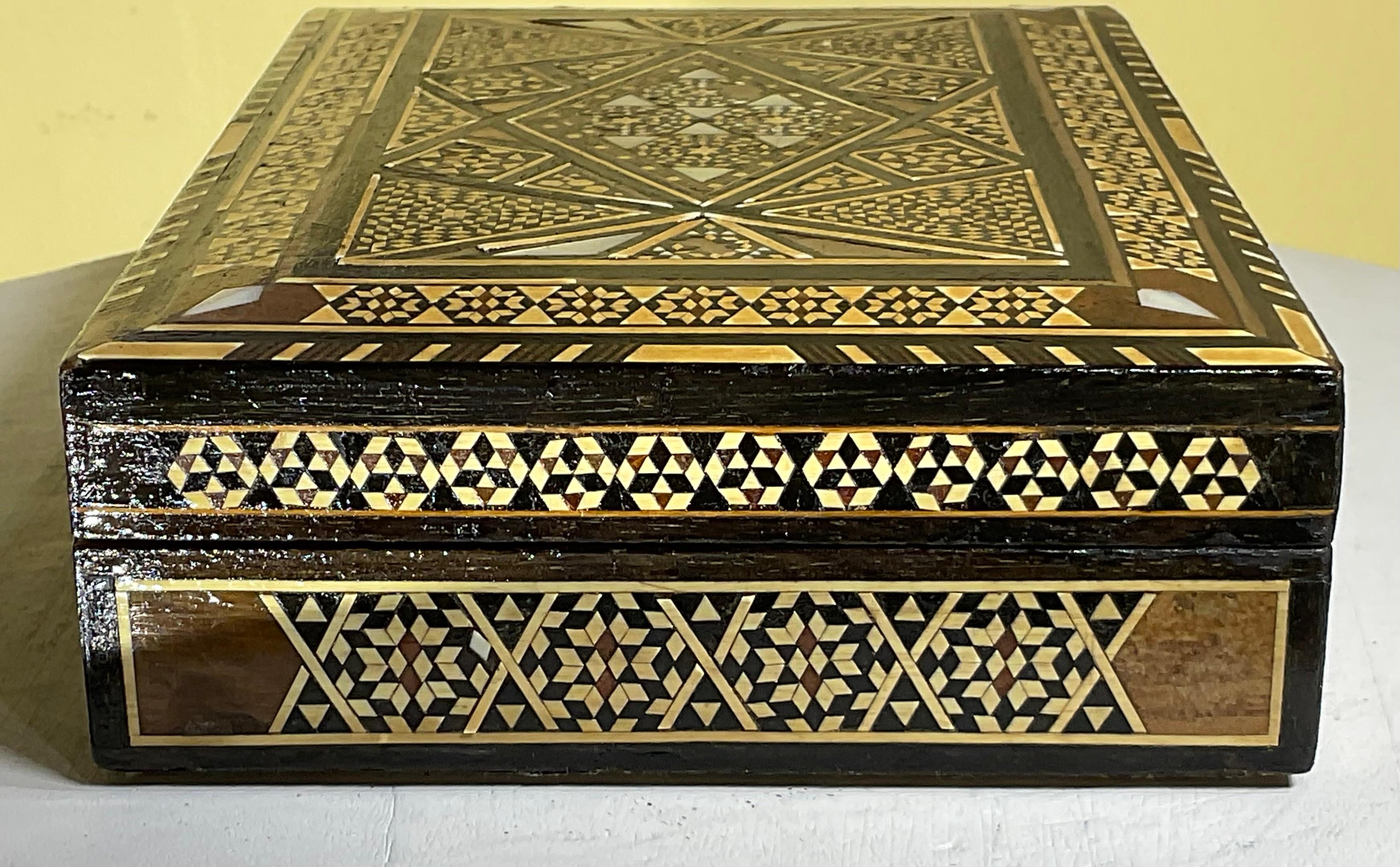  exquisite middle Eastern Moorish Syrian inlay jewelry box. This box is intricately inlaid with Moorish motif designs which have been uniquely inlaid with bone, mother of pearl and fruitwood.
 The box was professionally fully restored , some inlay