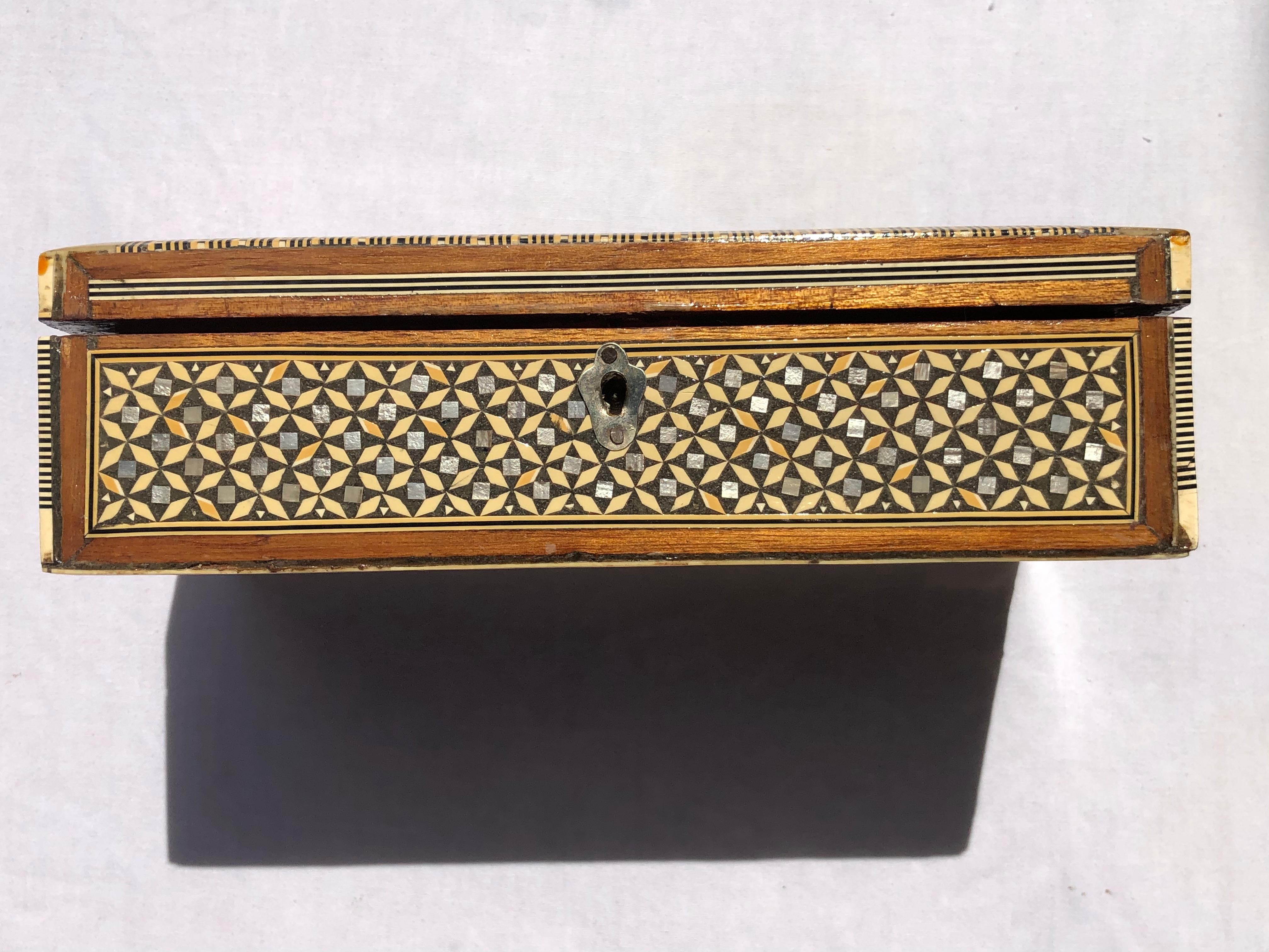 One of a kind, exquisite middle Eastern Moorish Syrian inlay jewelry box. This box is intricately inlaid with Moorish motif designs which have been uniquely inlaid with bone, mother of pearl and fruitwood.

This Jewelry box’s interior is lined
