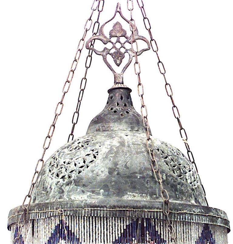 Middle Eastern Moorish-style (20th Century) patinated brass filigree 2 tiered chandelier with 8 bird head arms holding dome shades. Multicolored glass beaded fringe
