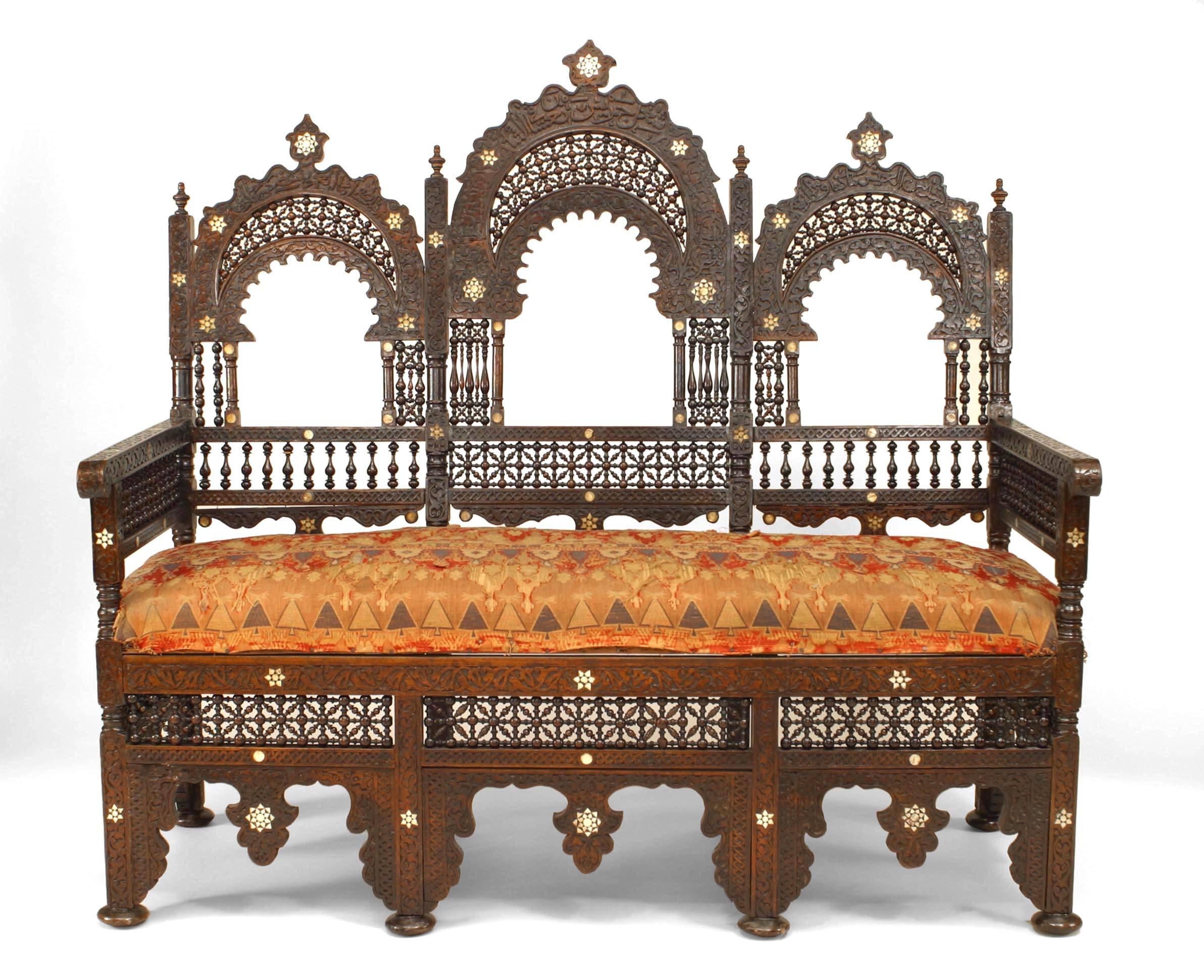 Middle Eastern Moorish walnut settee with spindle and ball design and pearl inlay with triple arch open design back with woven fabric seat (19th Cent.)

