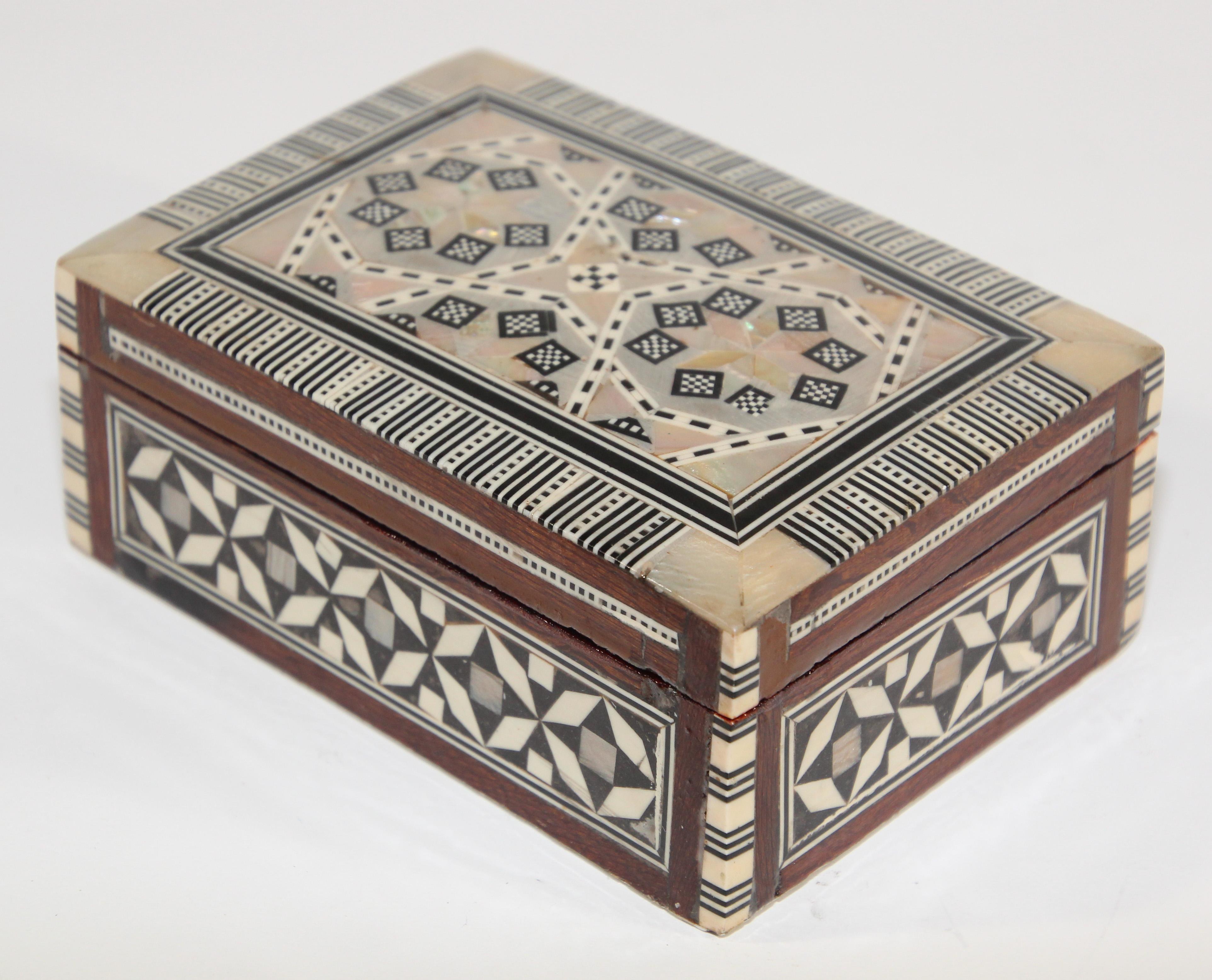 Handcrafted marquetry Moorish wood inlay micro mosaic inlaid with mother of pearl.
Handcrafted khatam wooden box with very delicate micro mosaic marquetry from the ancient Persian technique of inlaying from arrangements of so many delicate pieces