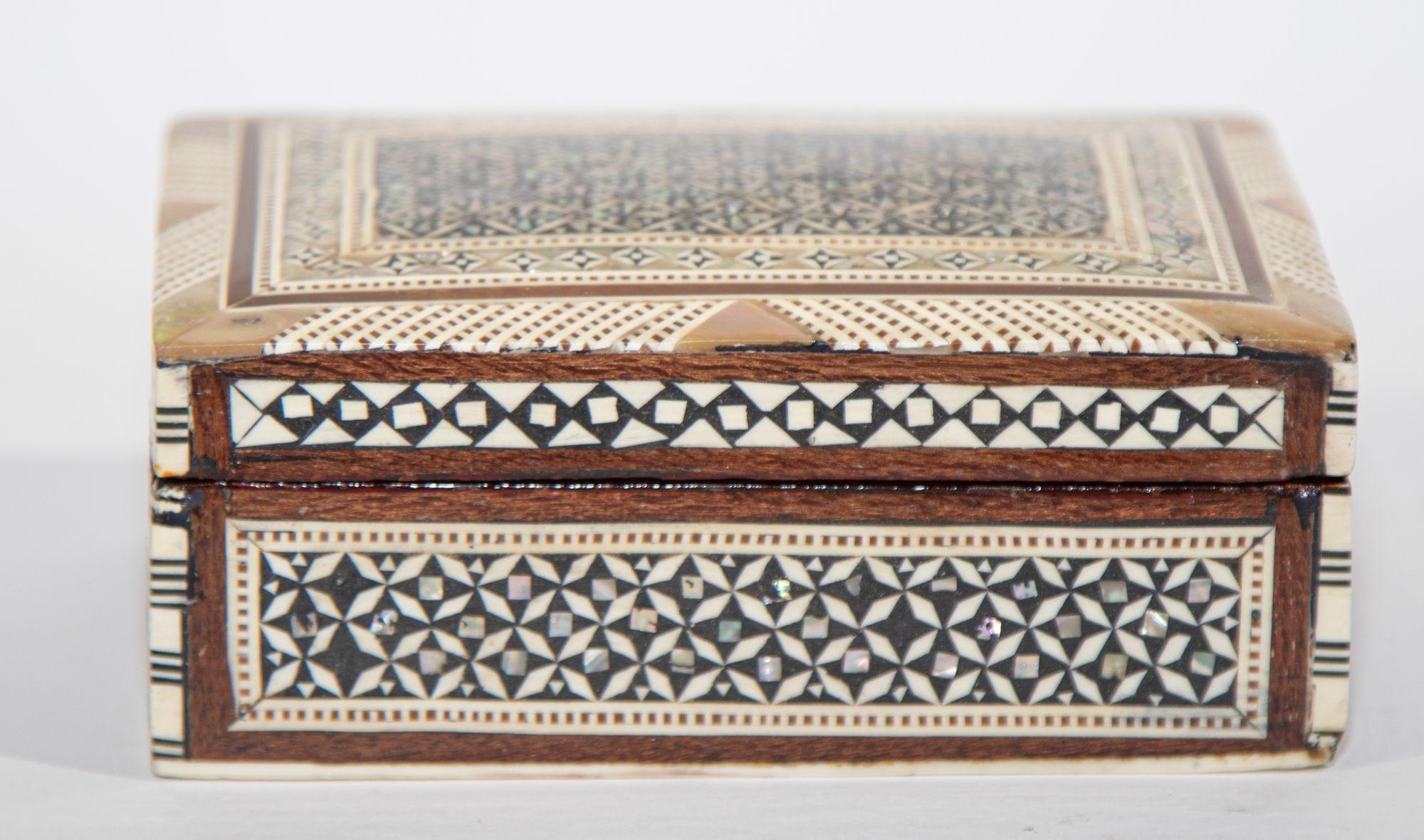 Middle Eastern Mosaic wood box with Inlays of bone and mother of Pearl, C. 1950s
Exquisite handcrafted Egyptian decorative wood box with mosaic marquetry design.
Vintage Moorish style box features geometric inlays in mother of pearl.
Outstanding