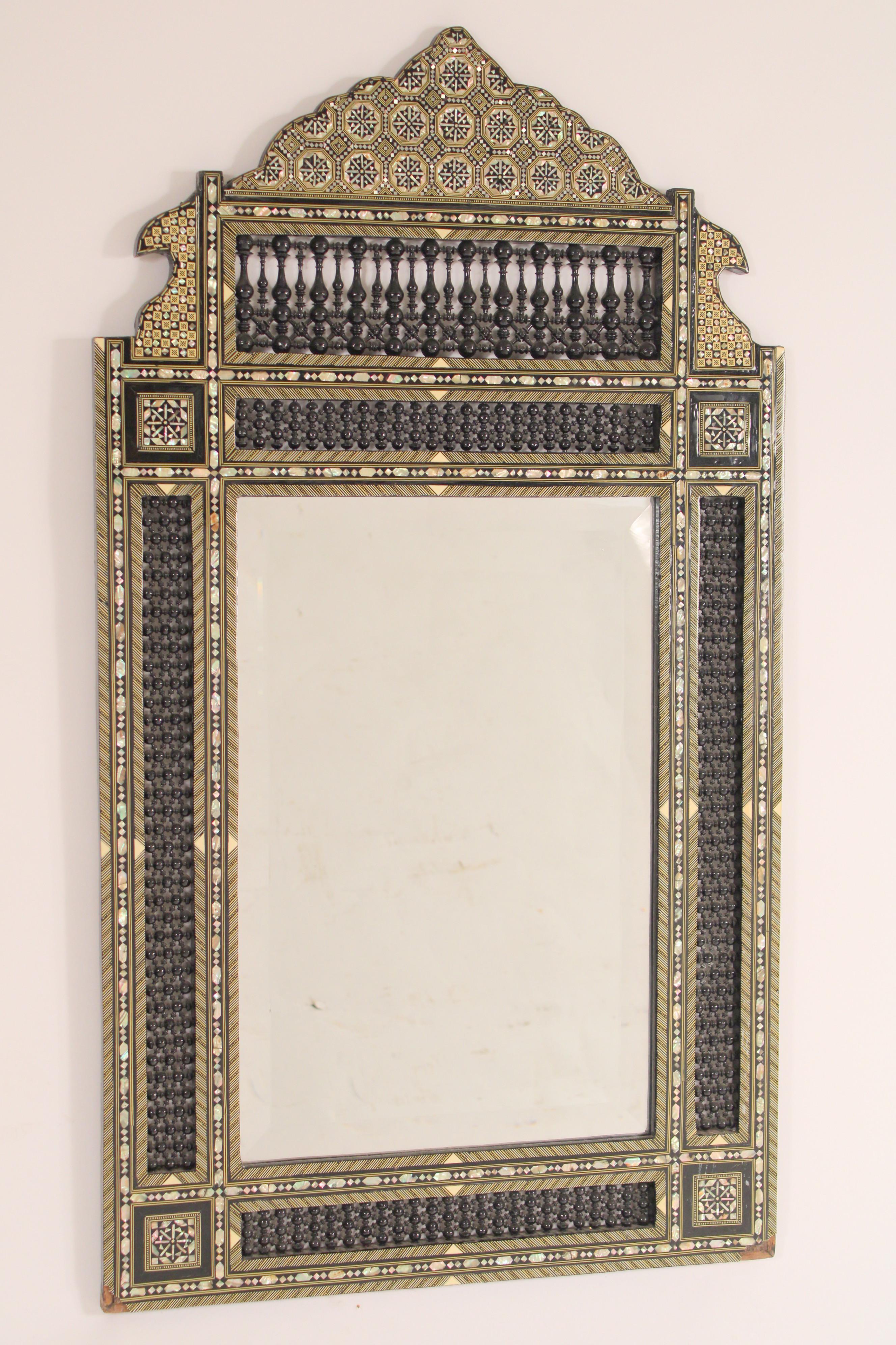 Middle Eastern mother of pearl and bone inlaid mirror, late 20th century. With mother of pearl and bone inlay. Turned decorations on top, sides and bottom. Very intricate detailed inlay on this mirror.